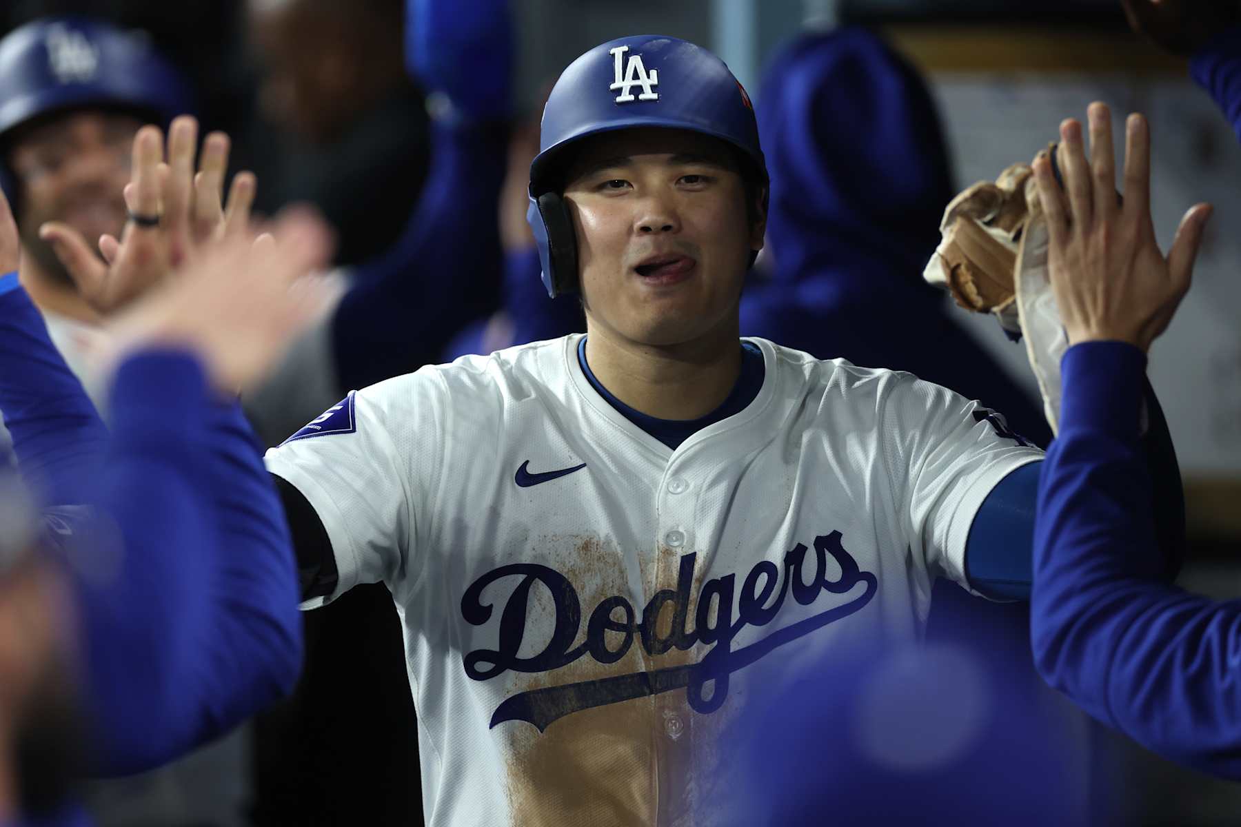 LOS ANGELES, CALIFORNIA - OCTOBER 13: Shohei Ohtani #17 of the Los Angeles Dodgers celebrates with teammates after scoring a run in the eighth inning against the New York Mets during Game One of the Championship Series at Dodger Stadium on October 13, 2024 in Los Angeles, California. (Photo by Sean M. Haffey/Getty Images)