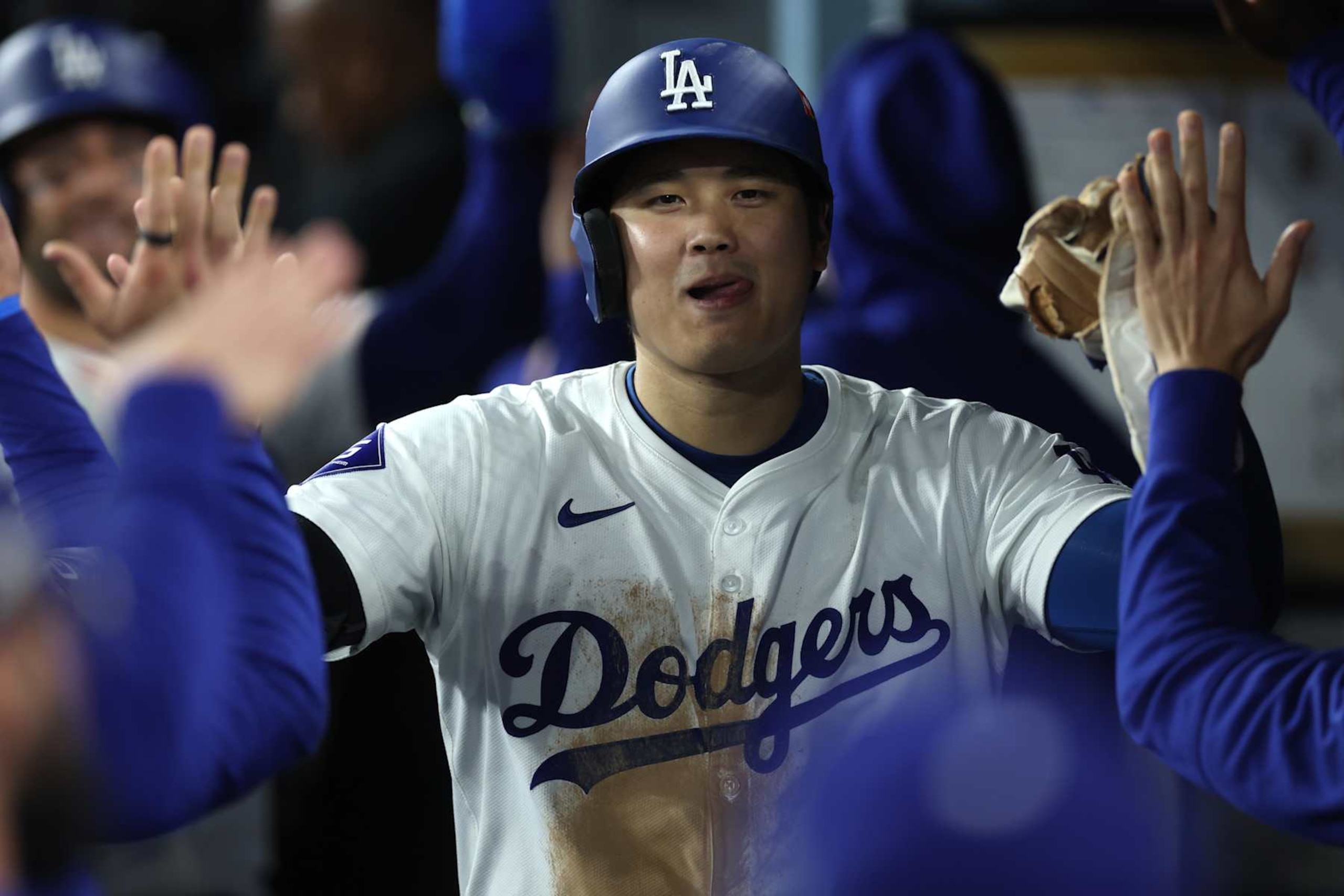 LOS ANGELES, CALIFORNIA - OCTOBER 13: Shohei Ohtani #17 of the Los Angeles Dodgers celebrates with teammates after scoring a run in the eighth inning against the New York Mets during Game One of the Championship Series at Dodger Stadium on October 13, 2024 in Los Angeles, California. (Photo by Sean M. Haffey/Getty Images)