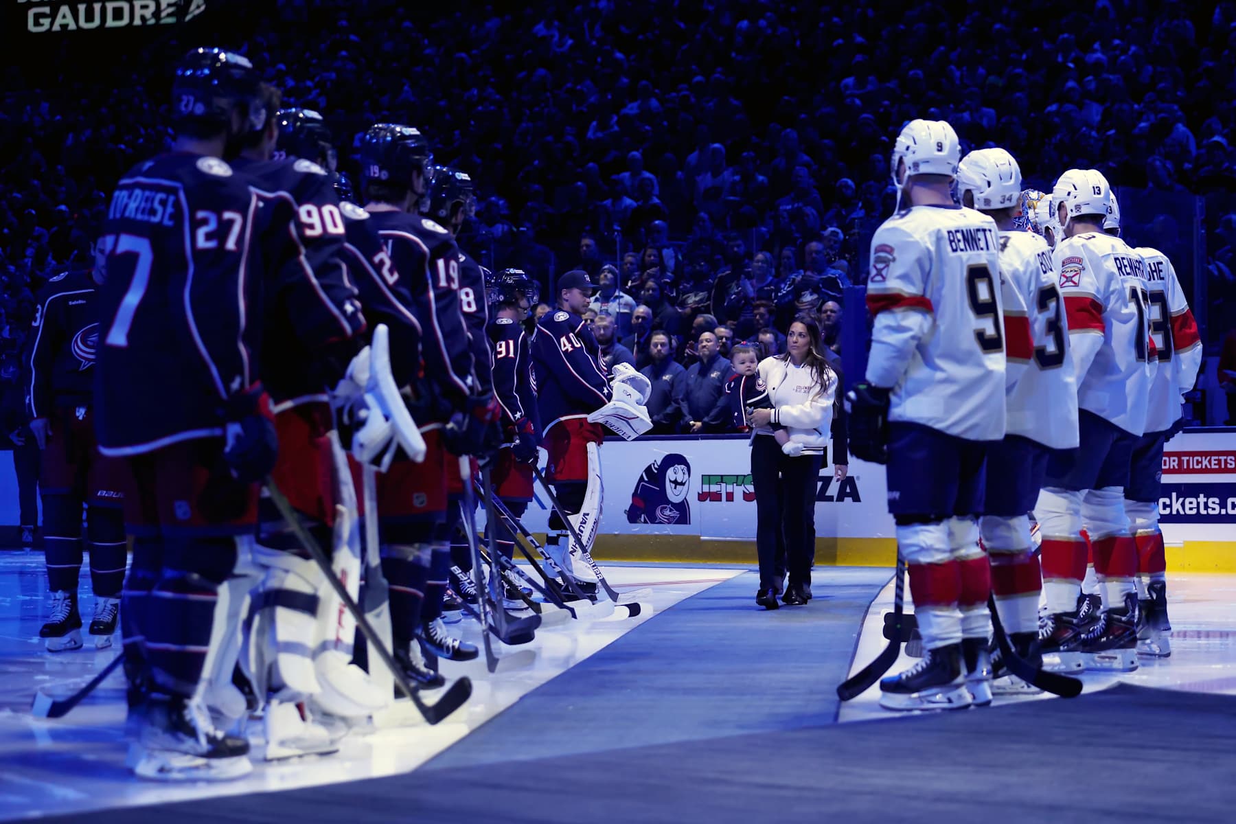 COLUMBUS, OHIO - OCTOBER 15:  Meredith Gaudreau, the wife of former Columbus Blue Jackets player Johnny Gaudreau, walks out onto the ice while carrying her child for remembrance ceremony prior to the start of the game between the Columbus Blue Jackets and the Florida Panthers at Nationwide Arena on October 15, 2024 in Columbus, Ohio. Gaudreau, who along with his brother Matthew, was killed by a suspected drunk driver on August 29, 2024. (Photo by Kirk Irwin/NHLI via Getty Images)
