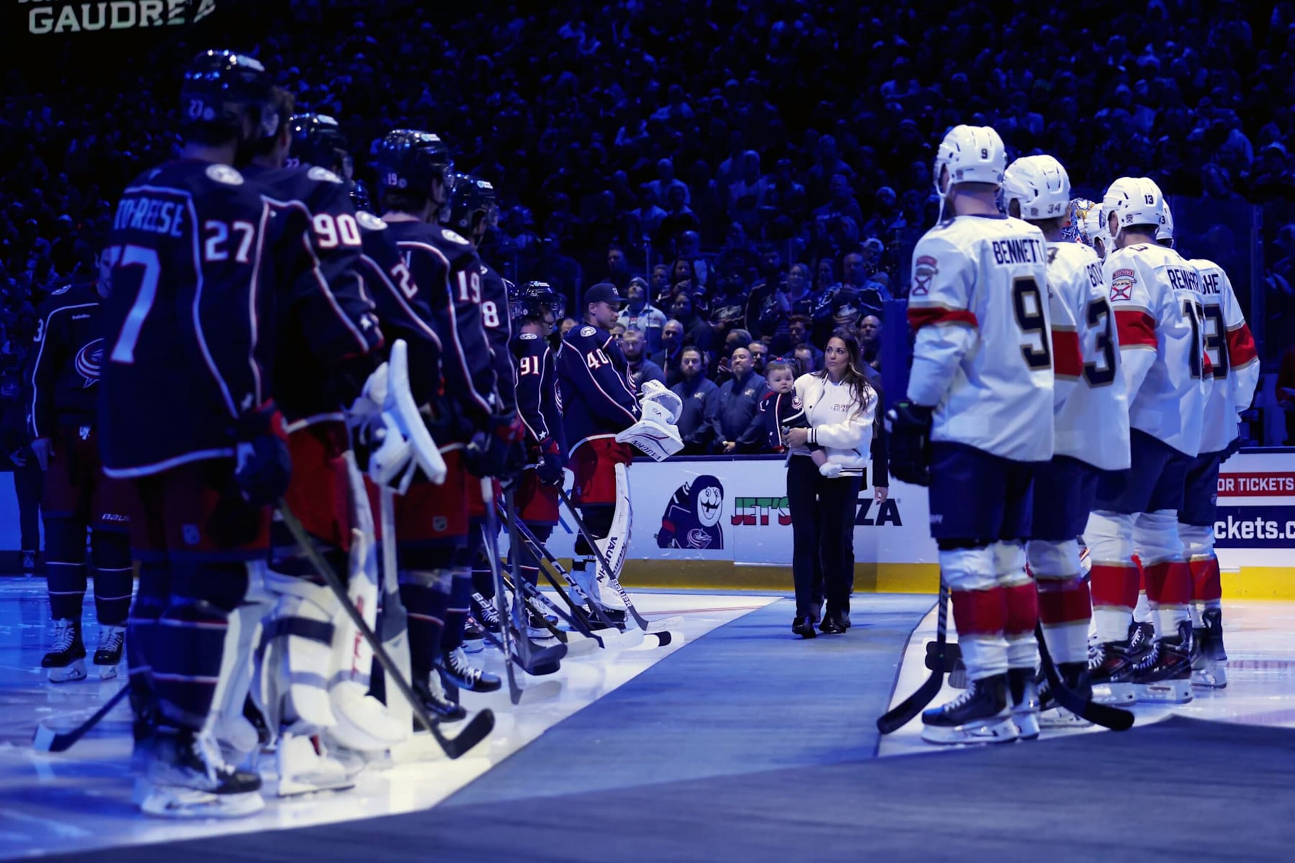 COLUMBUS, OHIO - OCTOBER 15:  Meredith Gaudreau, the wife of former Columbus Blue Jackets player Johnny Gaudreau, walks out onto the ice while carrying her child for remembrance ceremony prior to the start of the game between the Columbus Blue Jackets and the Florida Panthers at Nationwide Arena on October 15, 2024 in Columbus, Ohio. Gaudreau, who along with his brother Matthew, was killed by a suspected drunk driver on August 29, 2024. (Photo by Kirk Irwin/NHLI via Getty Images)