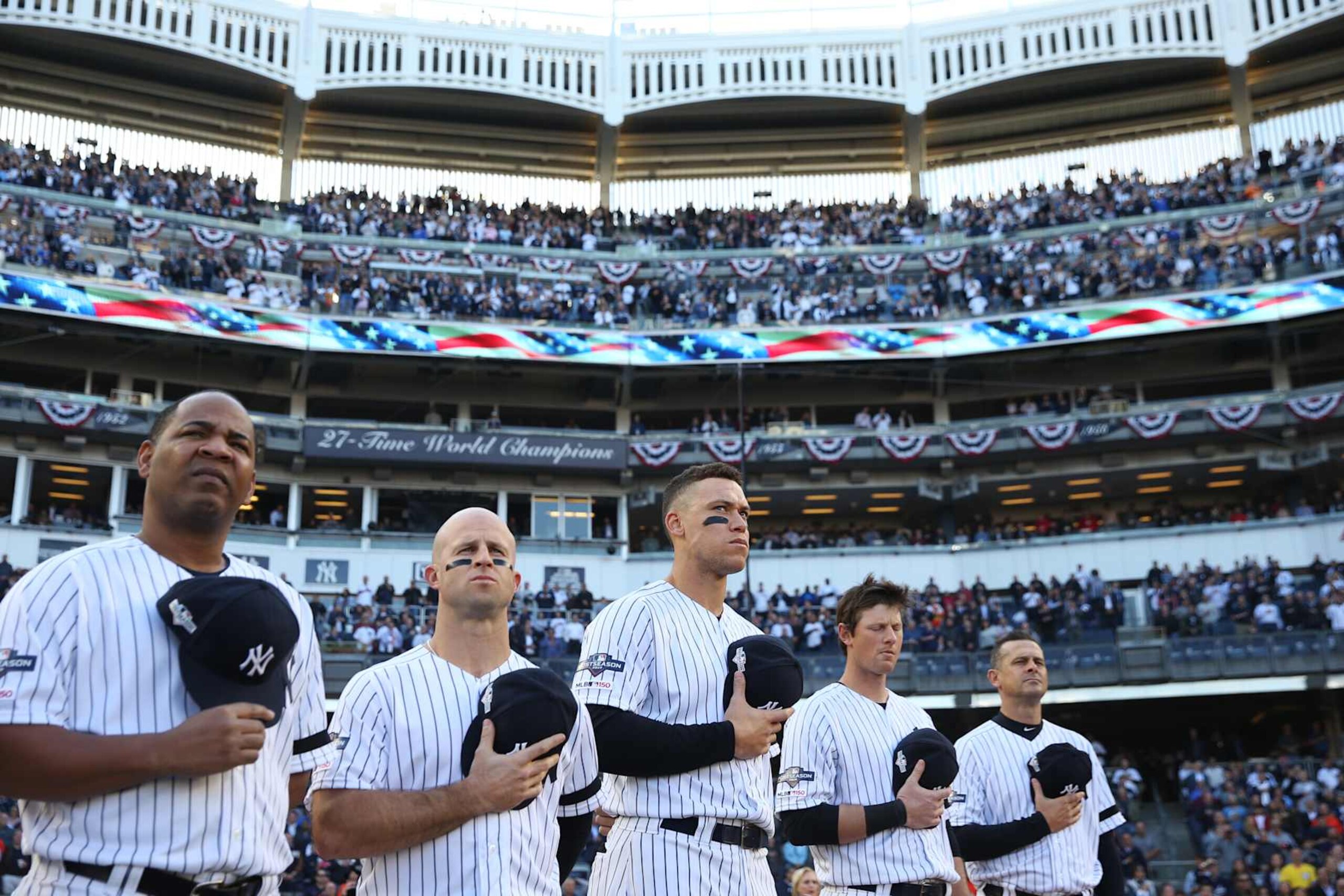 BRONX, NY - OCTOBER 15: Members of the New York Yankees stand for the national anthem prior to Game 3 of the ALCS between the Houston Astros and the New York Yankees at Yankee Stadium on Tuesday, October 15, 2019 in the Bronx borough of New York City. (Photo by Rob Tringali/MLB Photos via Getty Images)