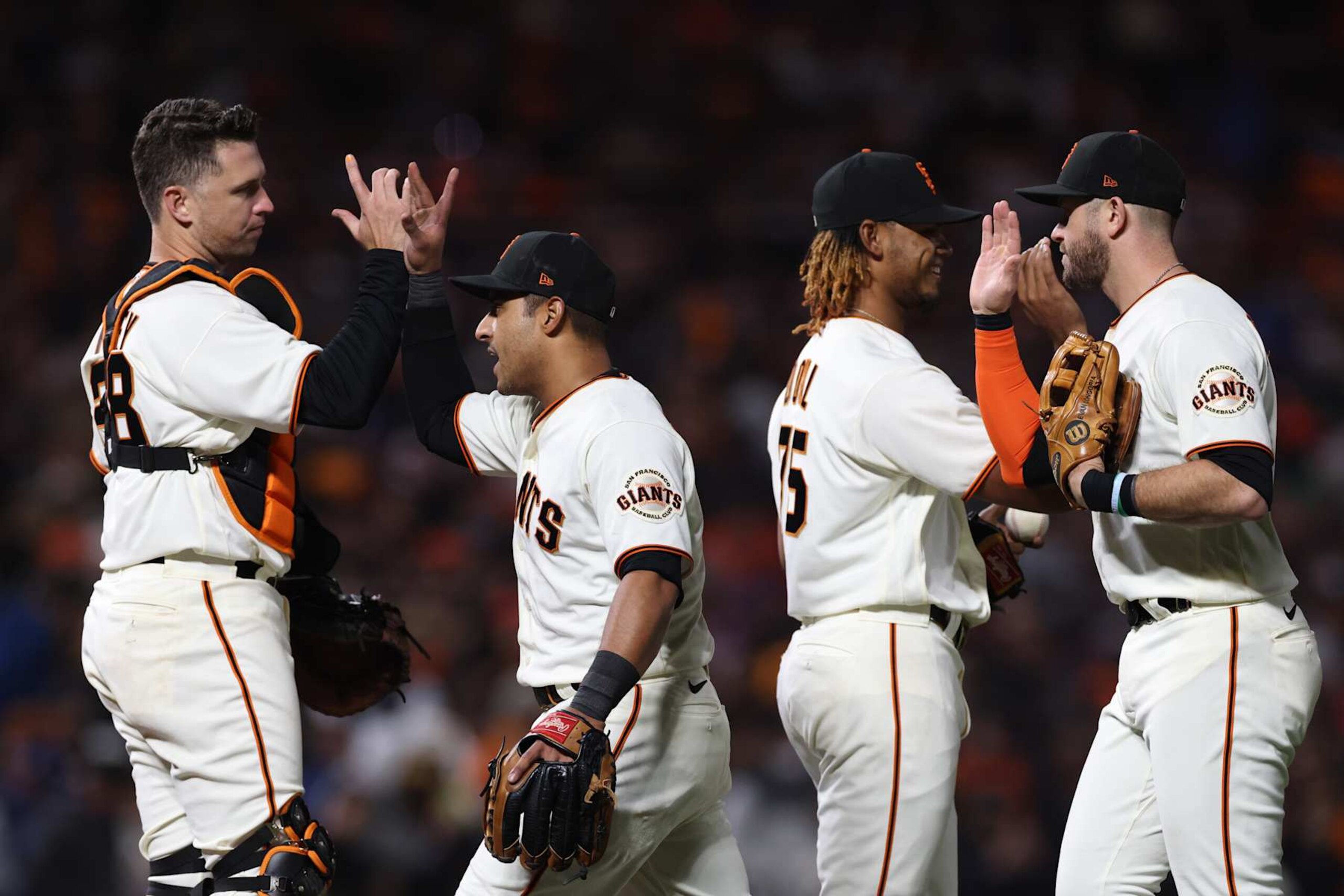 SAN FRANCISCO, CALIFORNIA - OCTOBER 08: Buster Posey #28, Donovan Solano #7, Camilo Doval #75 and Evan Longoria #10 of the San Francisco Giants celebrate after defeating the Los Angeles Dodgers 4-0 in Game 1 of the National League Division Series at Oracle Park on October 08, 2021 in San Francisco, California. (Photo by Harry How/Getty Images)