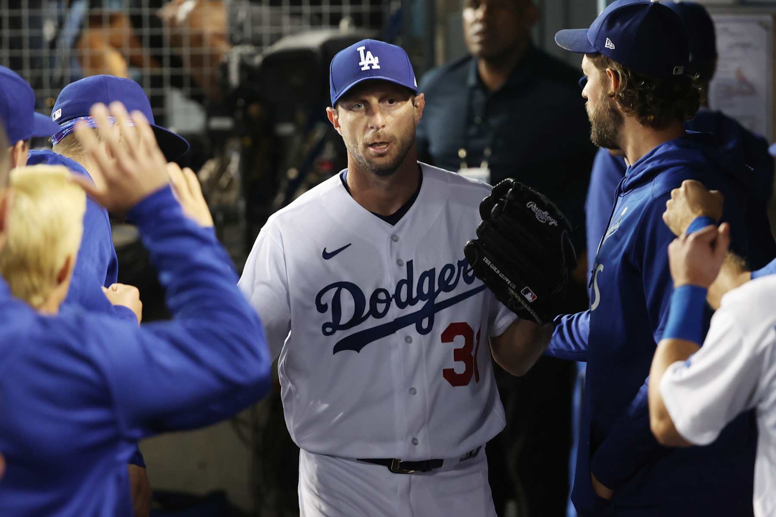 LOS ANGELES, CALIFORNIA - OCTOBER 06: Max Scherzer #31 of the Los Angeles Dodgers greets teammates in the dugout after being pulled from the game in the fifth inning against the St. Louis Cardinals during the National League Wild Card Game at Dodger Stadium on October 06, 2021 in Los Angeles, California. (Photo by Sean M. Haffey/Getty Images)