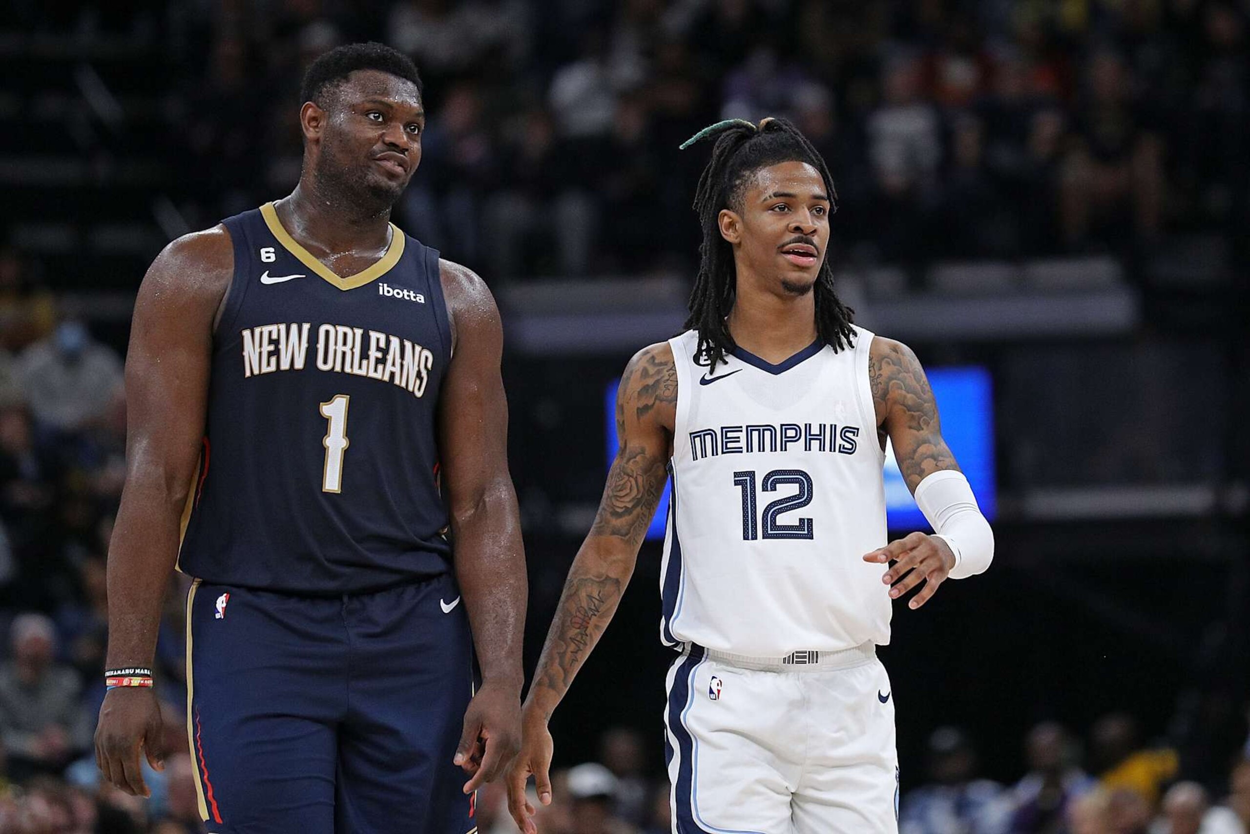 MEMPHIS, TENNESSEE - DECEMBER 31: Zion Williamson #1 of the New Orleans Pelicans and Ja Morant #12 of the Memphis Grizzlies during the game at FedExForum on December 31, 2022 in Memphis, Tennessee. NOTE TO USER: User expressly acknowledges and agrees that, by downloading and or using this photograph, User is consenting to the terms and conditions of the Getty Images License Agreement. (Photo by Justin Ford/Getty Images)