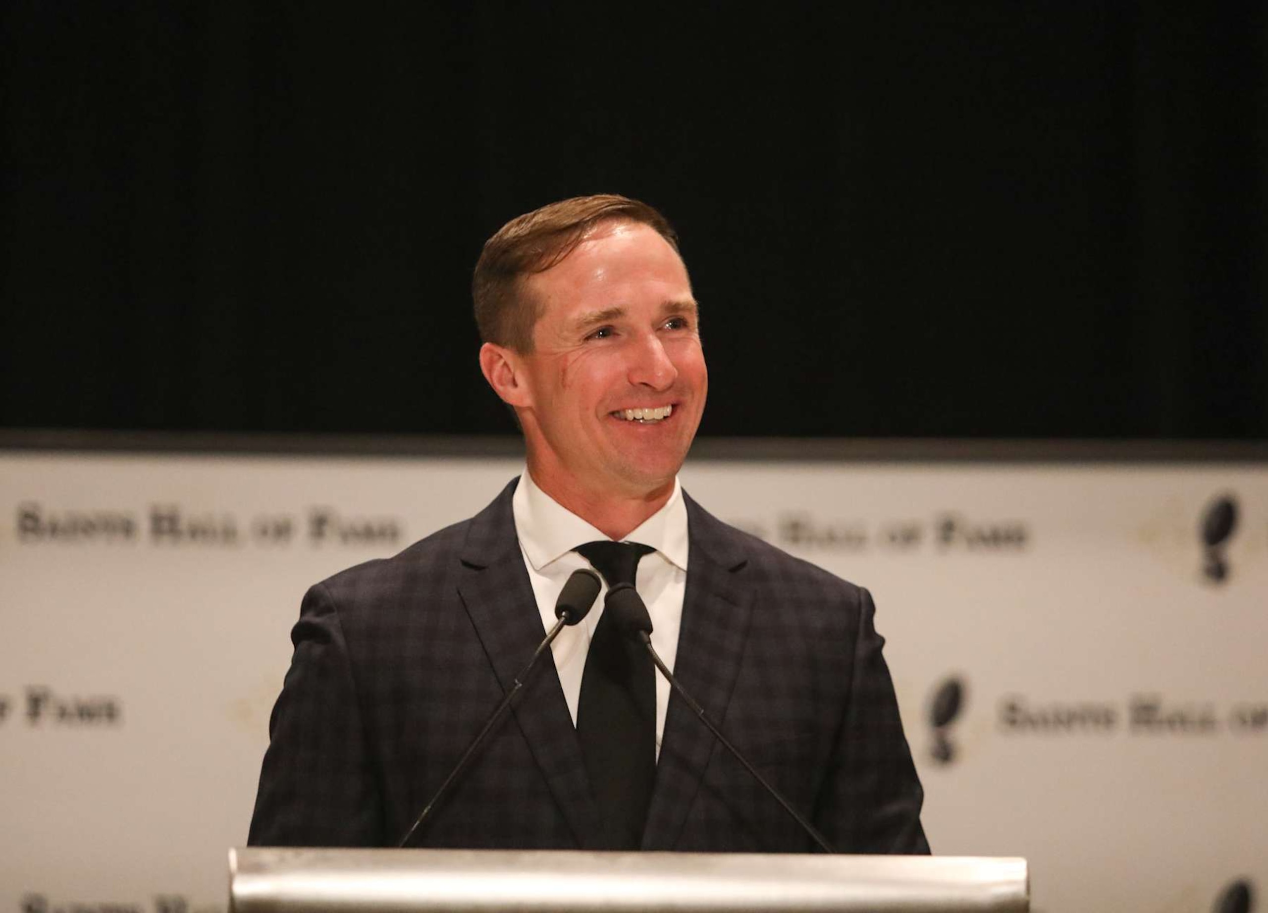 NEW ORLEANS, LOUISIANA - OCTOBER 17: Drew Brees speaks at his New Orleans Saints Hall Of Fame Induction luncheon on October 17, 2024 at Hilton Riverside in New Orleans, Louisiana. (Photo by Kaitlyn Morris/Getty Images) NEW ORLEANS, LOUISIANA - OCTOBER 17: Drew Brees speaks at his New Orleans Saints Hall Of Fame Induction luncheon on October 17, 2024 at Hilton Riverside in New Orleans, Louisiana. (Photo by Kaitlyn Morris/Getty Images)