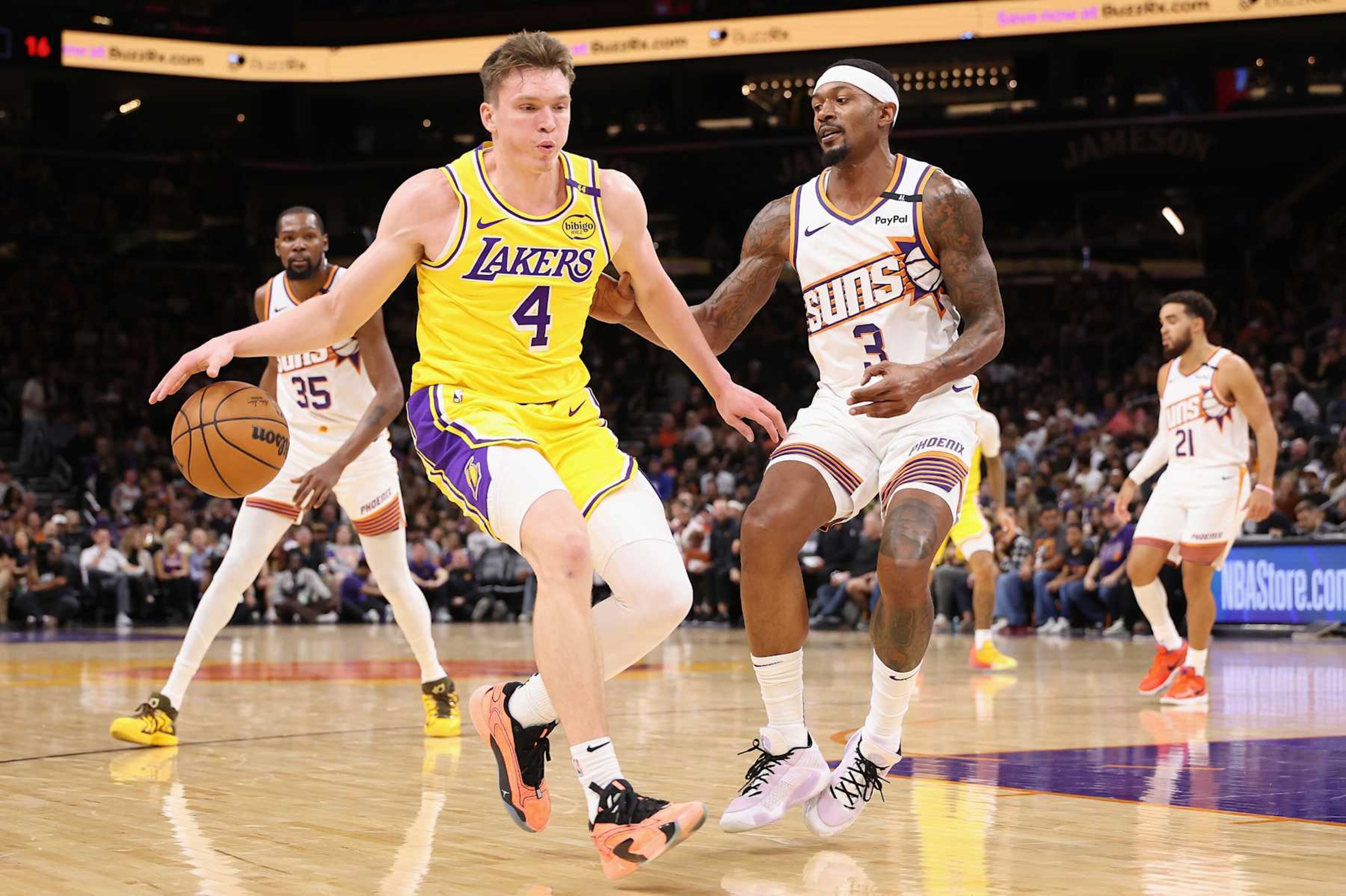 PHOENIX, ARIZONA - OCTOBER 17: Dalton Knecht #4 of the Los Angeles Lakers handles the ball against Bradley Beal #3 of the Phoenix Suns during the first half of the preseason NBA game at Footprint Center on October 17, 2024 in Phoenix, Arizona. NOTE TO USER: User expressly acknowledges and agrees that, by downloading and/or using this photograph, user is consenting to the terms and conditions of the Getty Images License Agreement. (Photo by Christian Petersen/Getty Images) PHOENIX, ARIZONA - OCTOBER 17: Dalton Knecht #4 of the Los Angeles Lakers handles the ball against Bradley Beal #3 of the Phoenix Suns during the first half of the preseason NBA game at Footprint Center on October 17, 2024 in Phoenix, Arizona. NOTE TO USER: User expressly acknowledges and agrees that, by downloading and/or using this photograph, user is consenting to the terms and conditions of the Getty Images License Agreement. (Photo by Christian Petersen/Getty Images)
