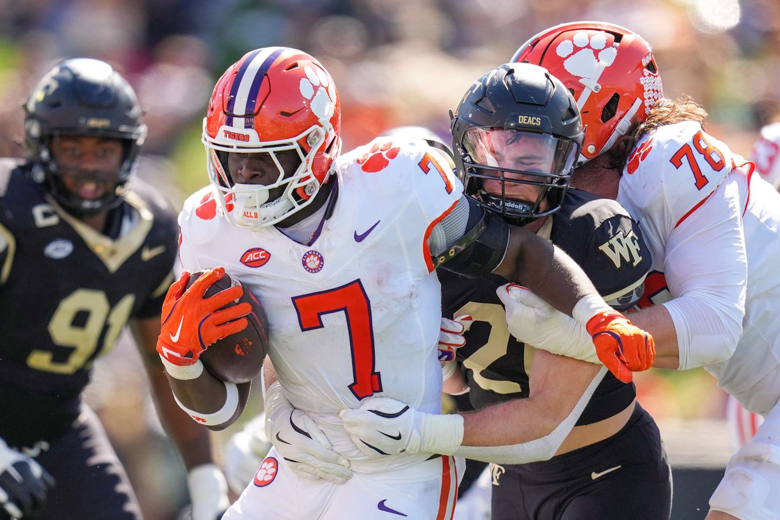WINSTON-SALEM, NORTH CAROLINA - OCTOBER 12: Branson Combs #21 of the Wake Forest Demon Deacons attempts to tackle Phil Mafah #7 of the Clemson Tigers during the first half of the game at Truist Field on October 12, 2024 in Winston-Salem, North Carolina.  (Photo by Grant Halverson/Getty Images)
