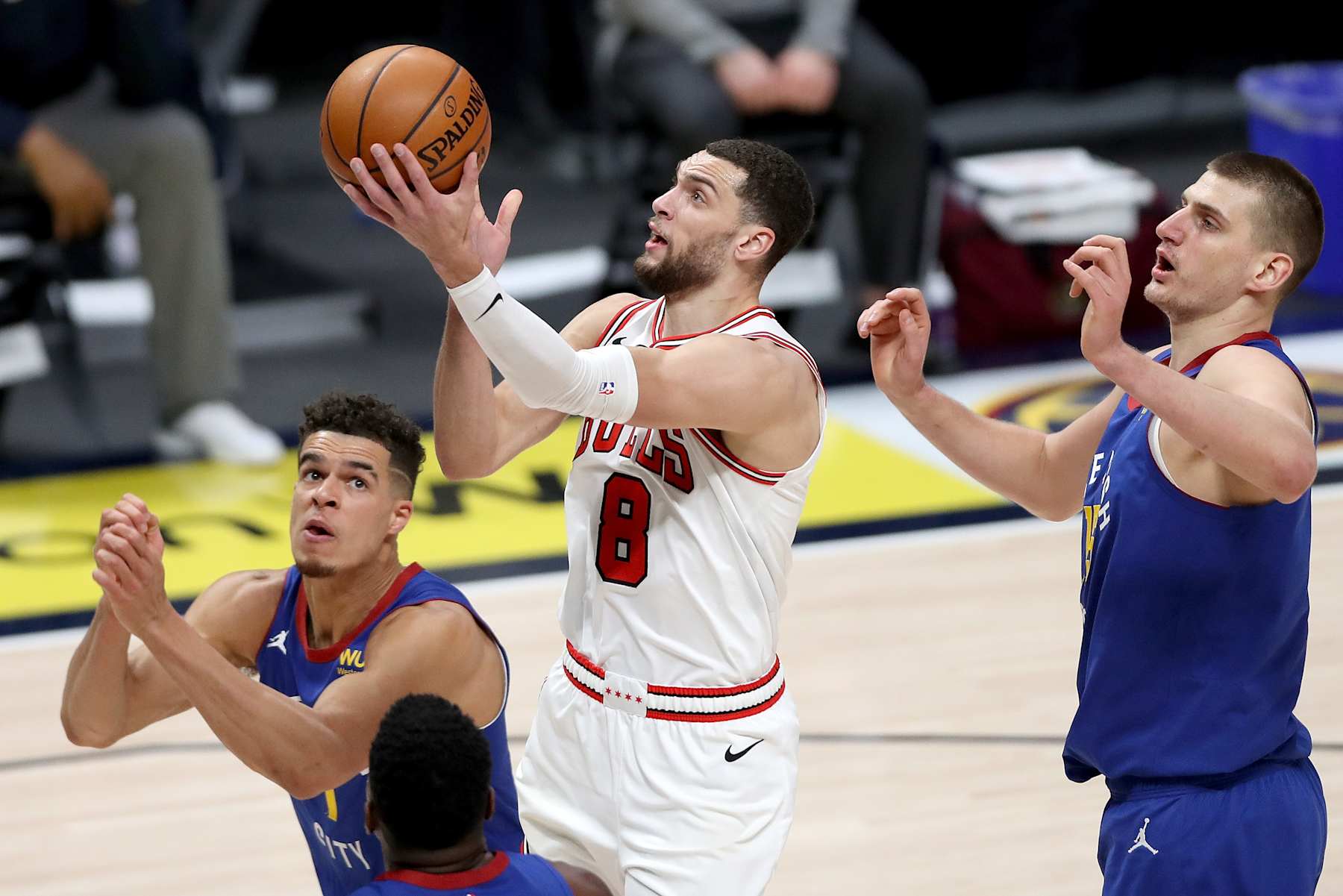 DENVER, COLORADO - MARCH 19: Zach LaVine #8 of the Chicago Bulls goes to the basket against Michael Porter Jr. #1 and Nikola Jokic #15 of the Denver Nuggets in the second quarter at Ball Arena on March 19, 2021 in Denver, Colorado. NOTE TO USER: User expressly acknowledges and agrees that, by downloading and or using this photograph, User is consenting to the terms and conditions of the Getty Images License Agreement. (Photo by Matthew Stockman/Getty Images)