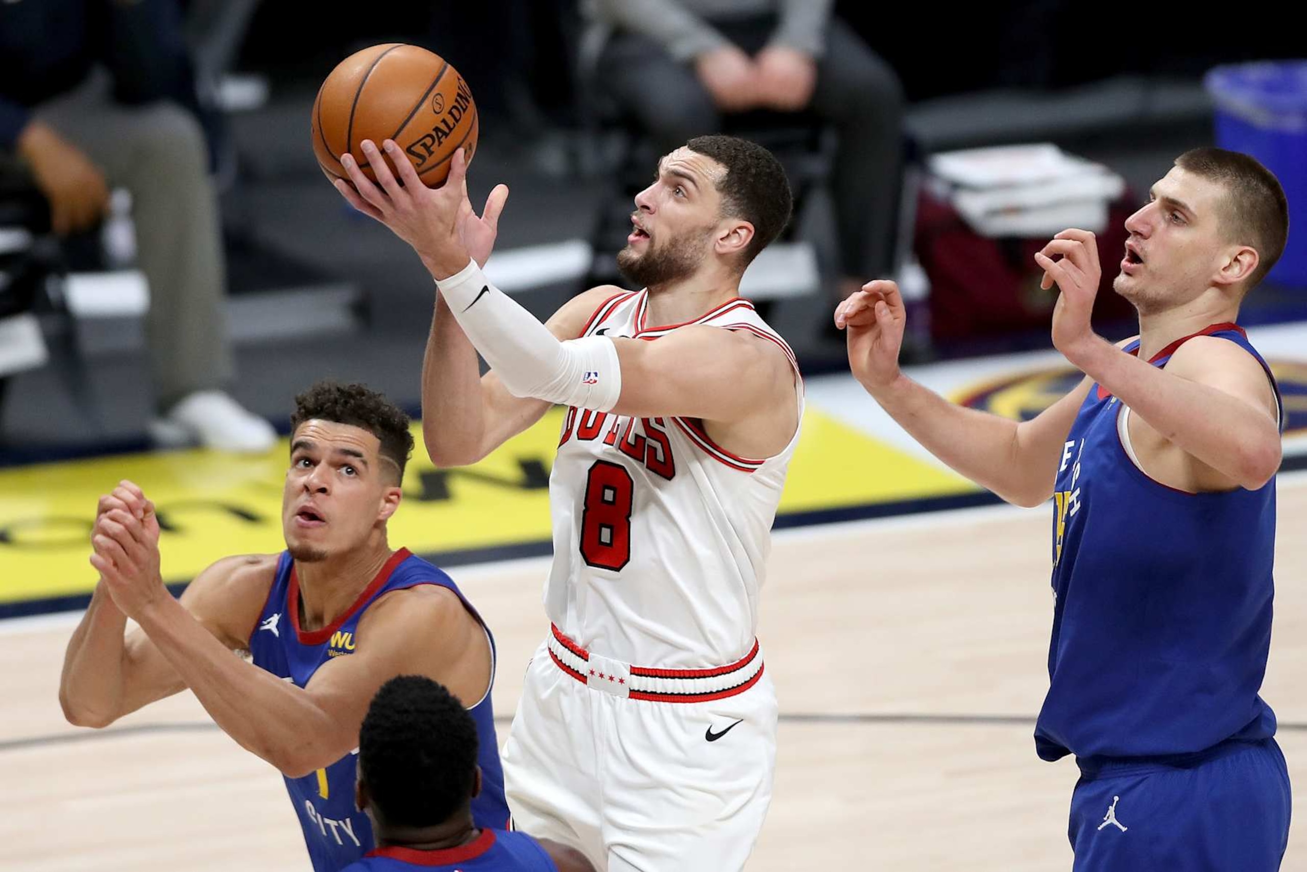 DENVER, COLORADO - MARCH 19: Zach LaVine #8 of the Chicago Bulls goes to the basket against Michael Porter Jr. #1 and Nikola Jokic #15 of the Denver Nuggets in the second quarter at Ball Arena on March 19, 2021 in Denver, Colorado. NOTE TO USER: User expressly acknowledges and agrees that, by downloading and or using this photograph, User is consenting to the terms and conditions of the Getty Images License Agreement. (Photo by Matthew Stockman/Getty Images)