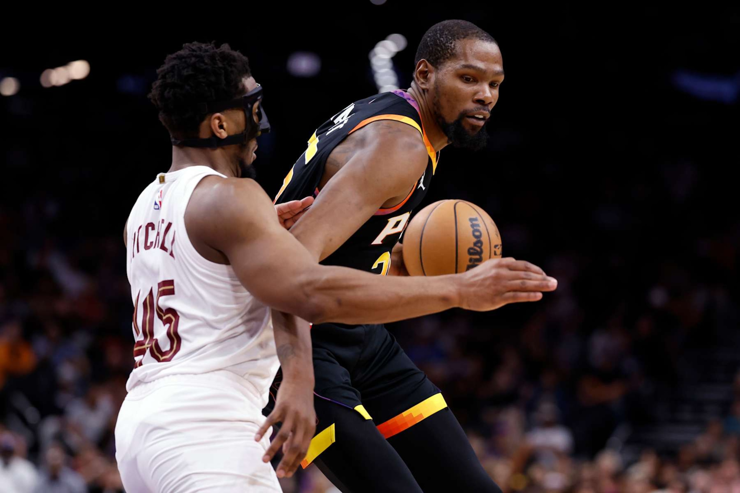 PHOENIX, ARIZONA - APRIL 03: Kevin Durant #35 of the Phoenix Suns posts up on Donovan Mitchell #45 of the Cleveland Cavaliers during the game at Footprint Center on April 03, 2024 in Phoenix, Arizona. The Suns defeated the Cavaliers 122-101. NOTE TO USER: User expressly acknowledges and agrees that, by downloading and or using this photograph, User is consenting to the terms and conditions of the Getty Images License Agreement.  (Photo by Chris Coduto/Getty Images)