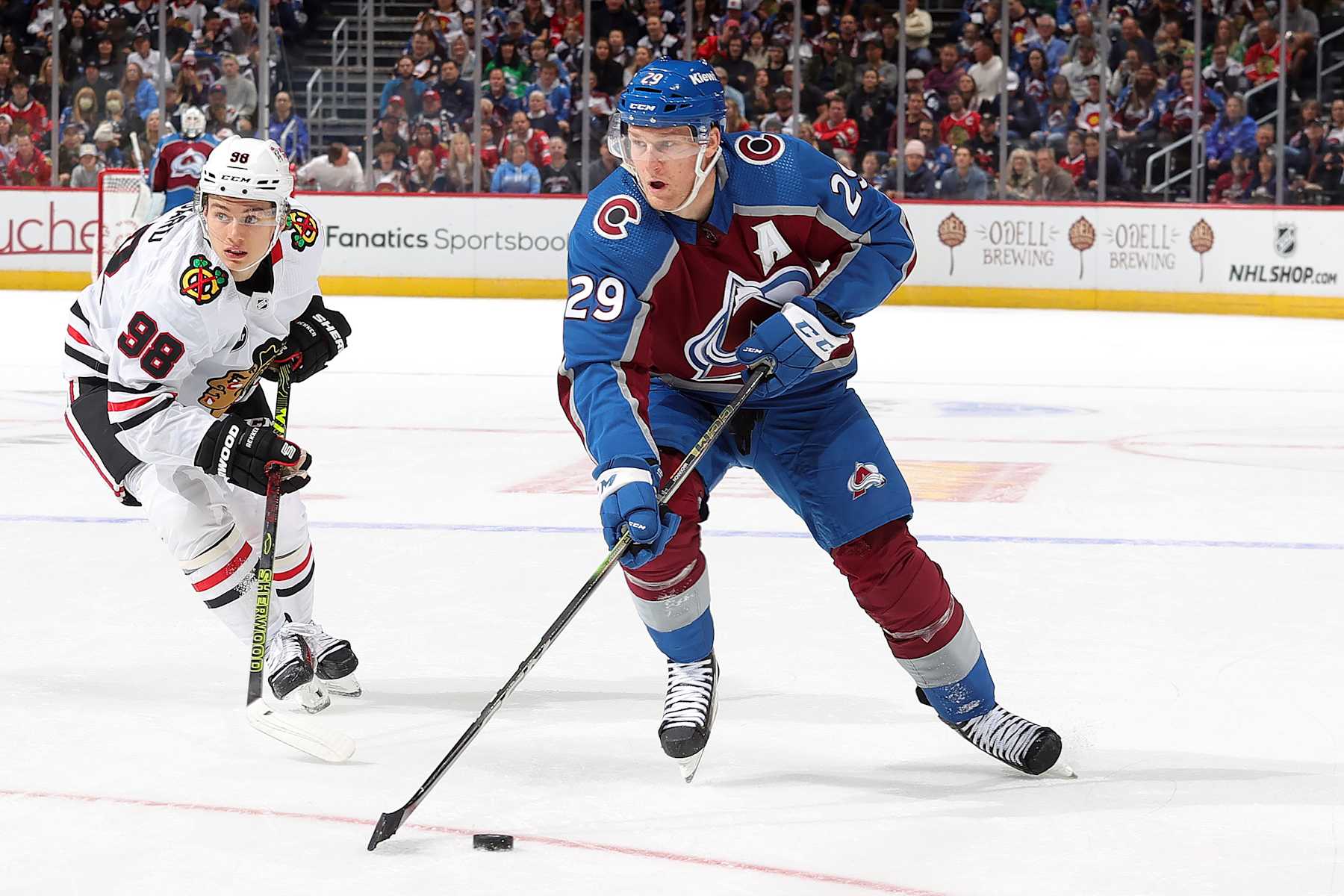 DENVER, COLORADO - OCTOBER 19: Nathan MacKinnon #29 of the Colorado Avalanche skates against Connor Bedard #98 of the Chicago Blackhawks at Ball Arena on October 19, 2023 in Denver, Colorado. (Photo by Michael Martin/NHLI via Getty Images)