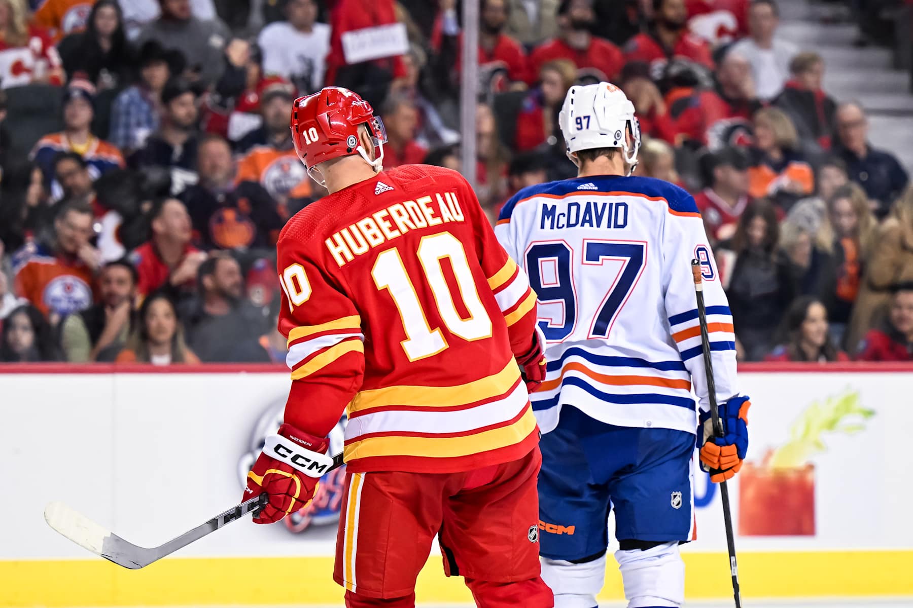 CALGARY, AB - OCTOBER 29: Calgary Flames Left Wing Jonathan Huberdeau (10) and Edmonton Oilers Center Connor McDavid (97) skate between whistles during the third period of an NHL game between the Calgary Flames and the Edmonton Oilers on October 29, 2022, at the Scotiabank Saddledome in Calgary, AB. (Photo by Brett Holmes/Icon Sportswire via Getty Images)