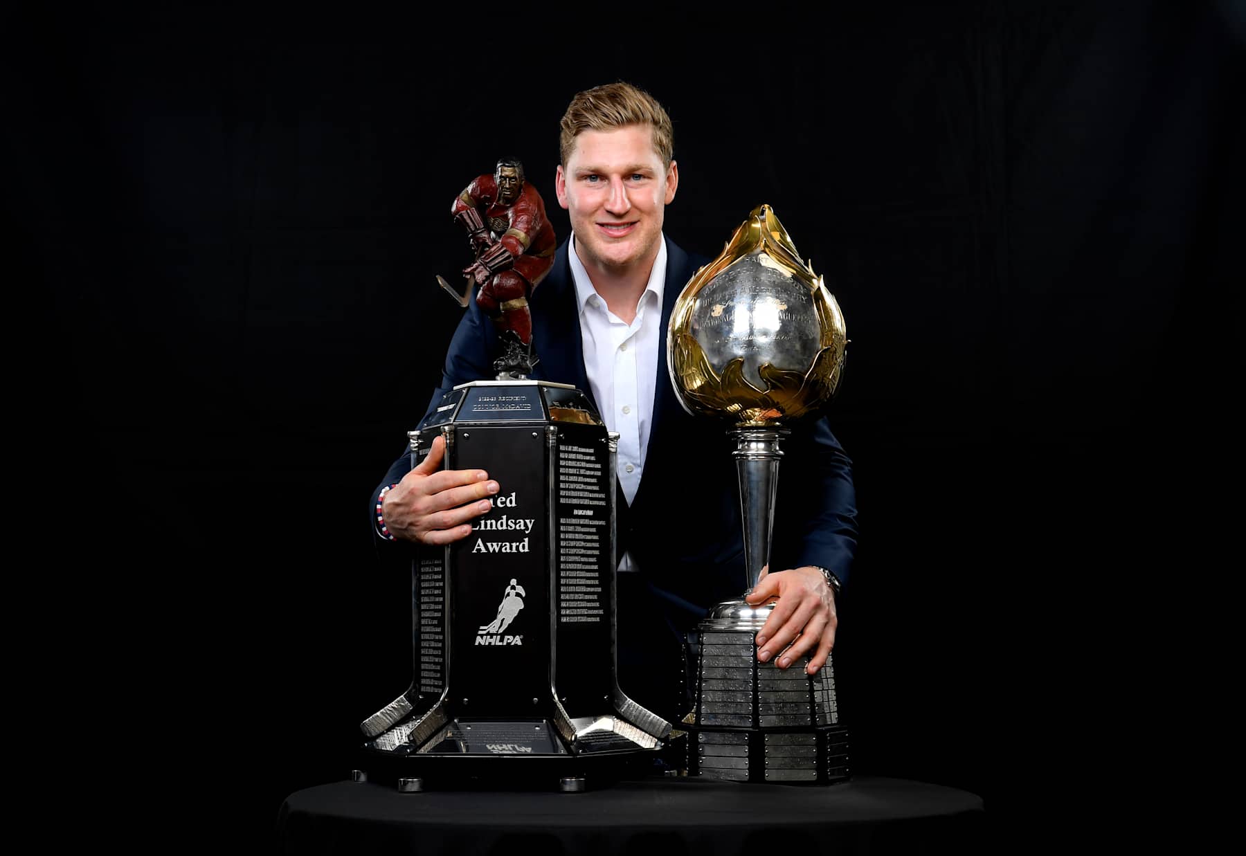 LAS VEGAS, NEVADA - JUNE 27: Nathan MacKinnon of the Colorado Avalanche poses for a portrait with the Ted Lindsay Award (L) and the Hart Memorial Trophy (R) during the 2024 NHL Awards at Fontainebleau Las Vegas on June 27, 2024 in Las Vegas, Nevada. (Photo by Brian Babineau/NHLI via Getty Images)