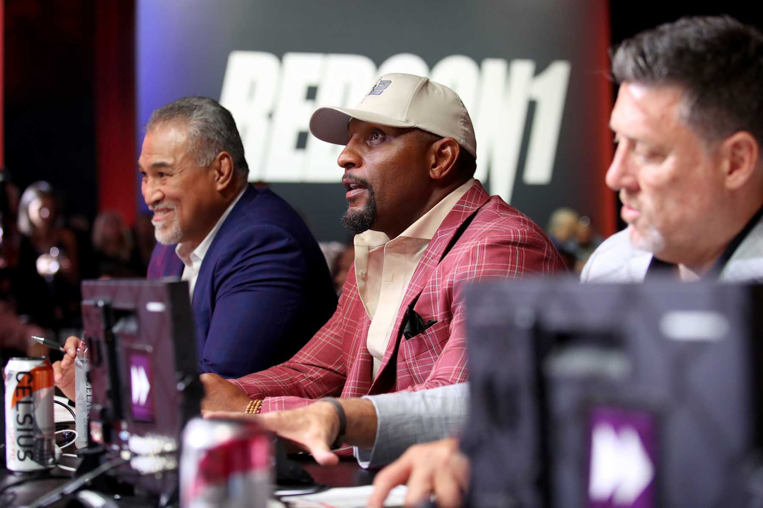 Ray Lewis sits between PFL executives Ray Sefo and Peter Murray. 