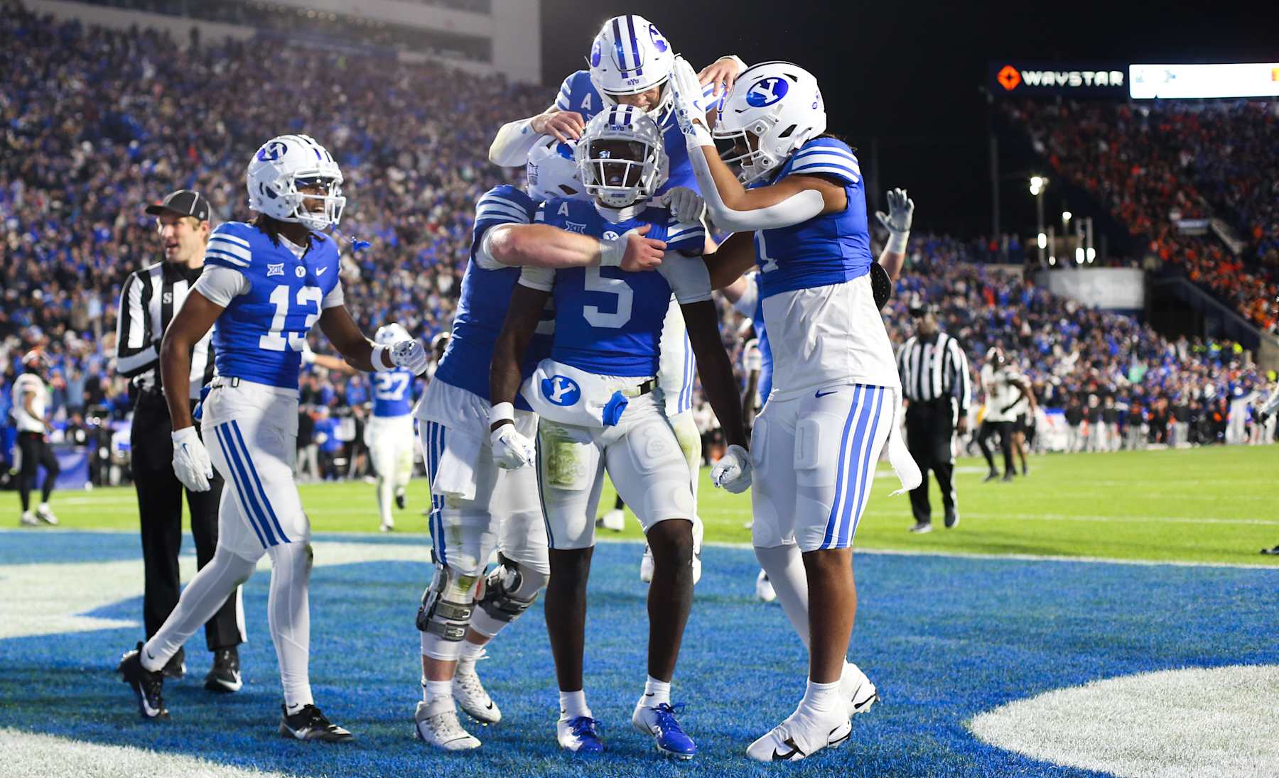 PROVO, UT - OCTOBER 18:  Darius Lassiter #5 of the Brigham Young Cougars is congratulated by teammates after scoring the game winning touchdown against the Oklahoma State Cowboys during the second half of their game at LaVell Edwards Stadium on October 18, 2024 in Provo, Utah.(Photo by Chris Gardner/Getty Images)