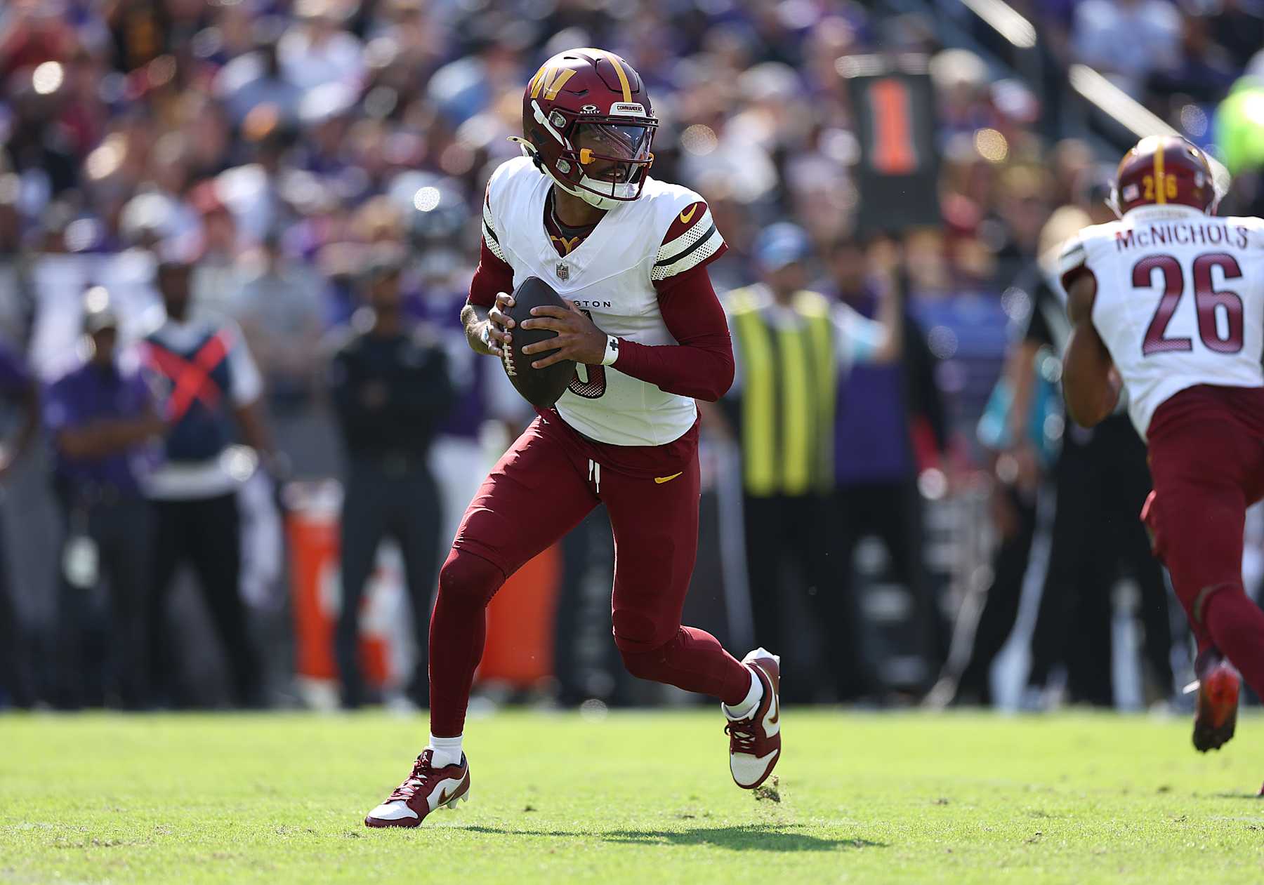 BALTIMORE, MARYLAND - OCTOBER 13: Jayden Daniels #5 of the Washington Commanders looks to pass against the Baltimore Ravens during the second quarter at M&T Bank Stadium on October 13, 2024 in Baltimore, Maryland. (Photo by Patrick Smith/Getty Images)