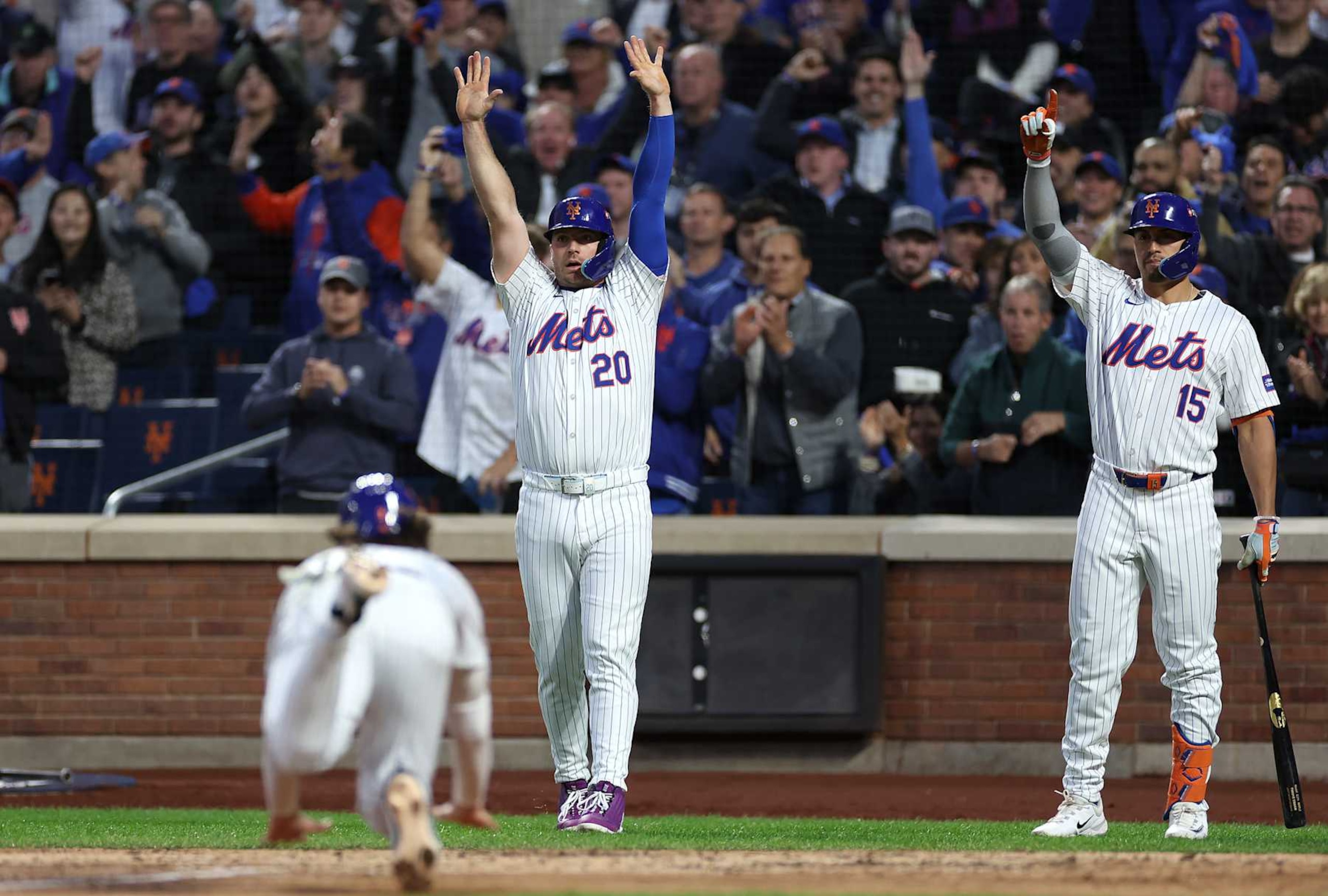 NEW YORK, NEW YORK - OCTOBER 18: Pete Alonso #20 of the New York Mets and Tyrone Taylor #15 react as Jesse Winker #3 scores a run in the third inning against the Los Angeles Dodgers during Game Five of the National League Championship Series at Citi Field on October 18, 2024 in New York City. (Photo by Sarah Stier/Getty Images) NEW YORK, NEW YORK - OCTOBER 18: Pete Alonso #20 of the New York Mets and Tyrone Taylor #15 react as Jesse Winker #3 scores a run in the third inning against the Los Angeles Dodgers during Game Five of the National League Championship Series at Citi Field on October 18, 2024 in New York City. (Photo by Sarah Stier/Getty Images)