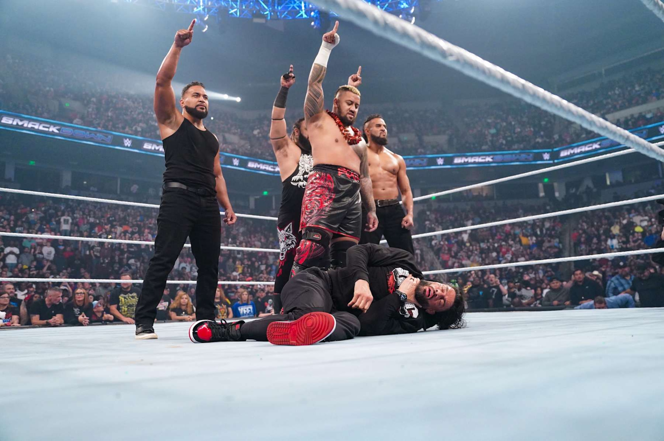 COLUMBIA, SOUTH CAROLINA - OCTOBER 18: Solo Siko, Jacob Fatu, Tonga Loa and Tama Tonga stand over Roman Reigns during SmackDown at Colonial Life Arena on October 18, 2024 in Columbia, South Carolina.  (Photo by WWE/Getty Images)