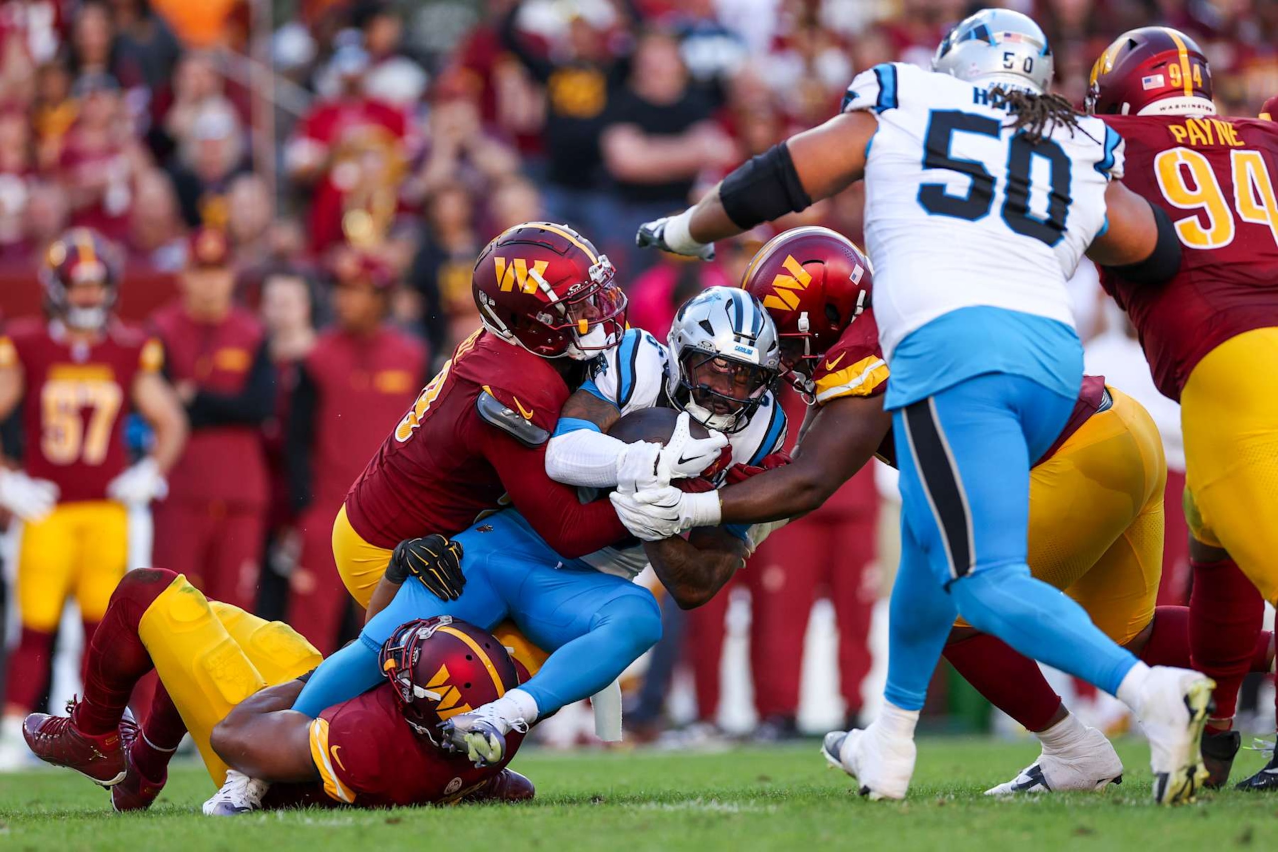 LANDOVER, MARYLAND - OCTOBER 20: Miles Sanders #6 of the Carolina Panthers is stopped by the Washington Commanders during the second quarter at FedExField on October 20, 2024 in Landover, Maryland. (Photo by Patrick Smith/Getty Images)