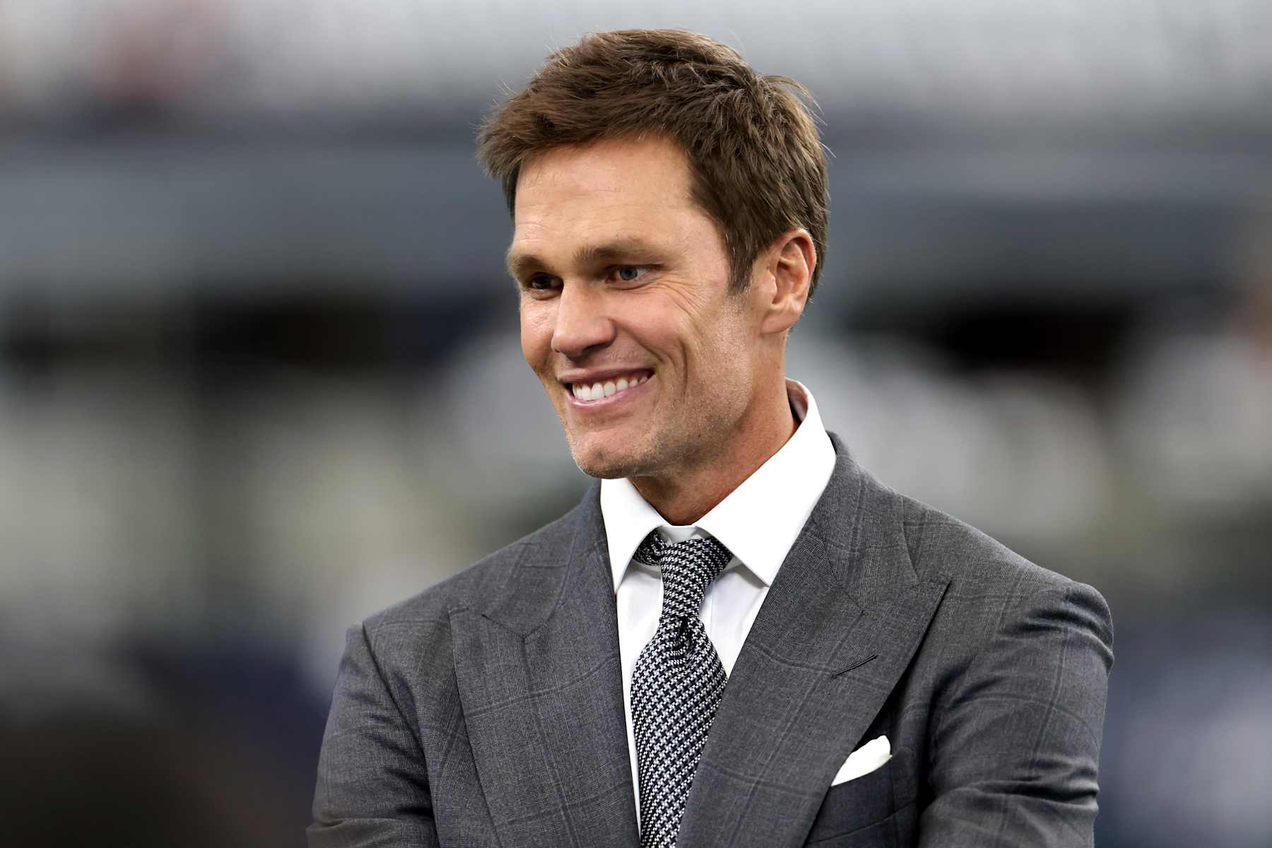 ARLINGTON, TEXAS - OCTOBER 13: Tom Brady, former NFL quarterback, looks on before the Detroit Lions play the Dallas Cowboys at AT&T Stadium on October 13, 2024 in Arlington, Texas. (Photo by Ron Jenkins/Getty Images)