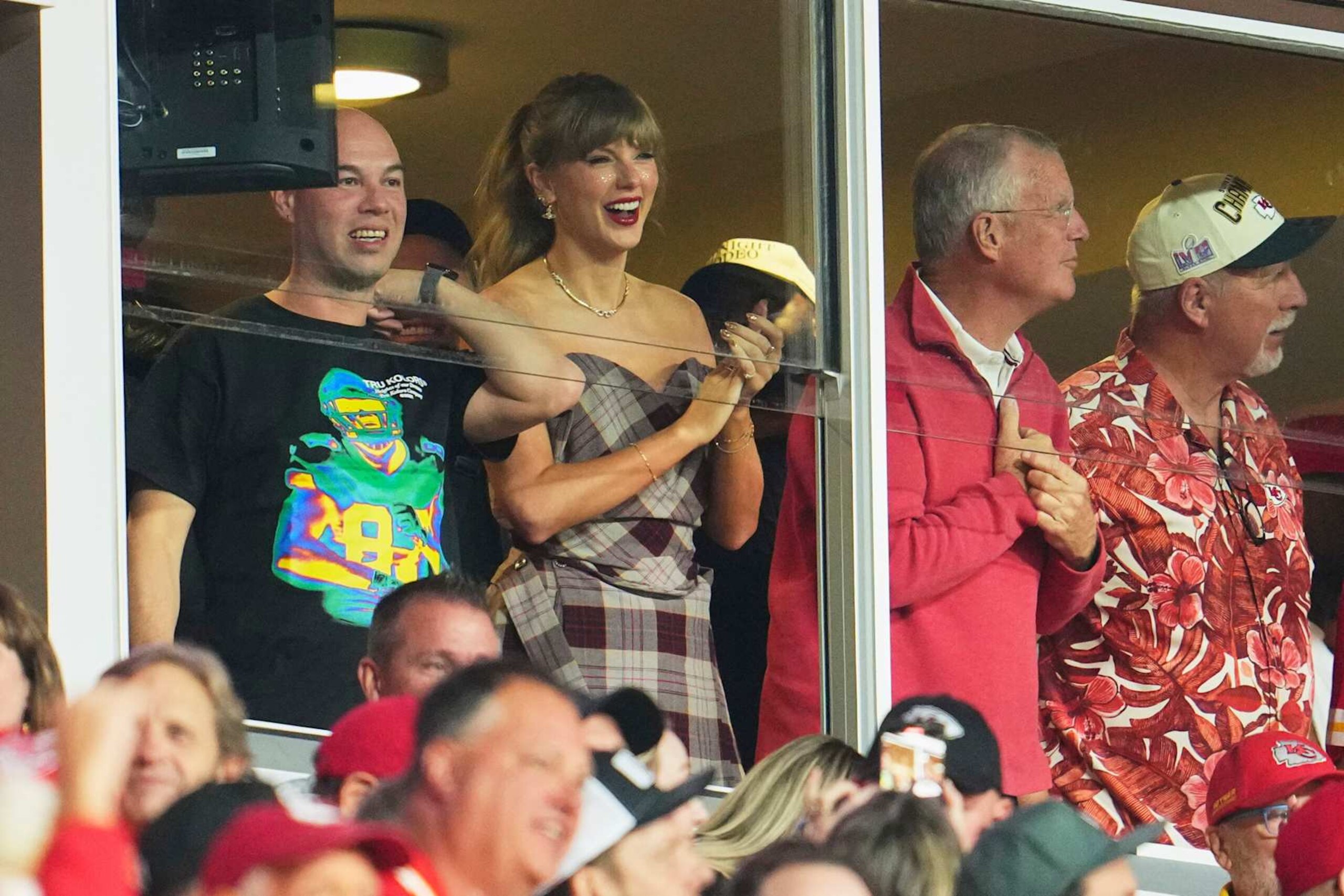 KANSAS CITY, MO - OCTOBER 07: Taylor Swift cheers from a suite as the Kansas City Chiefs play the New Orleans Saints during the first half of an NFL football game at GEHA Field at Arrowhead Stadium on October 7, 2024 in Kansas City, Missouri. (Photo by Cooper Neill/Getty Images)