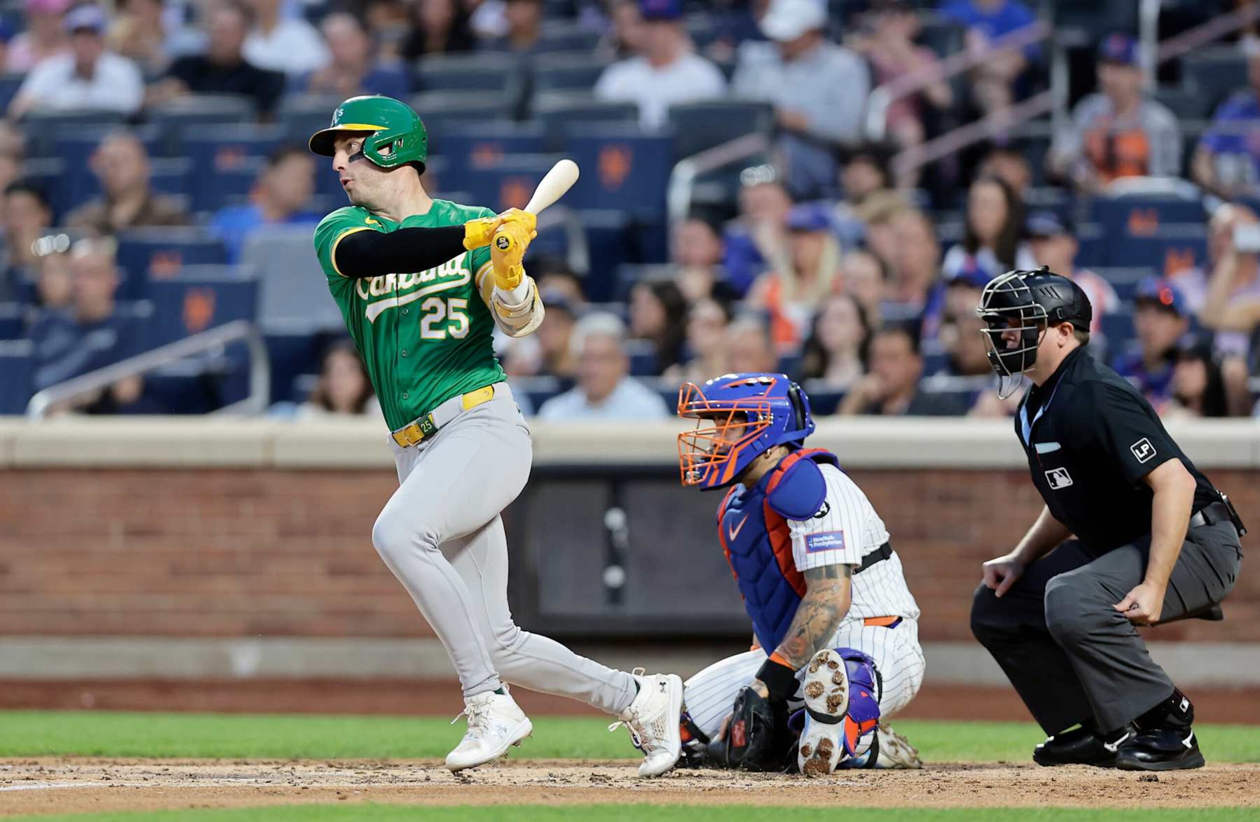 NEW YORK, NEW YORK - AUGUST 13:  Brent Rooker #25 of the Oakland Athletics follows through on his third inning single against the New York Mets at Citi Field on August 13, 2024 in New York City. The Athletics defeated the Mets 9-4. (Photo by Jim McIsaac/Getty Images)