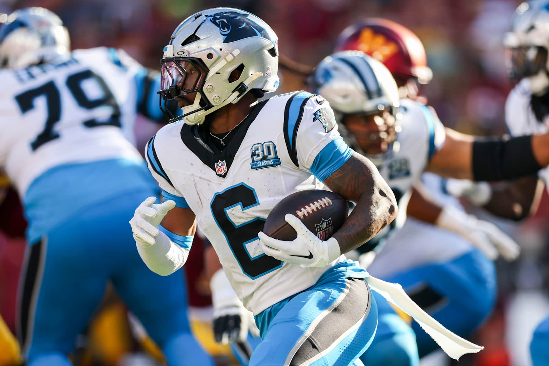 LANDOVER, MARYLAND - OCTOBER 20: Miles Sanders #6 of the Carolina Panthers runs the ball against the Washington Commanders during the first quarter at Northwest Stadium on October 20, 2024 in Landover, Maryland. (Photo by Patrick Smith/Getty Images)
