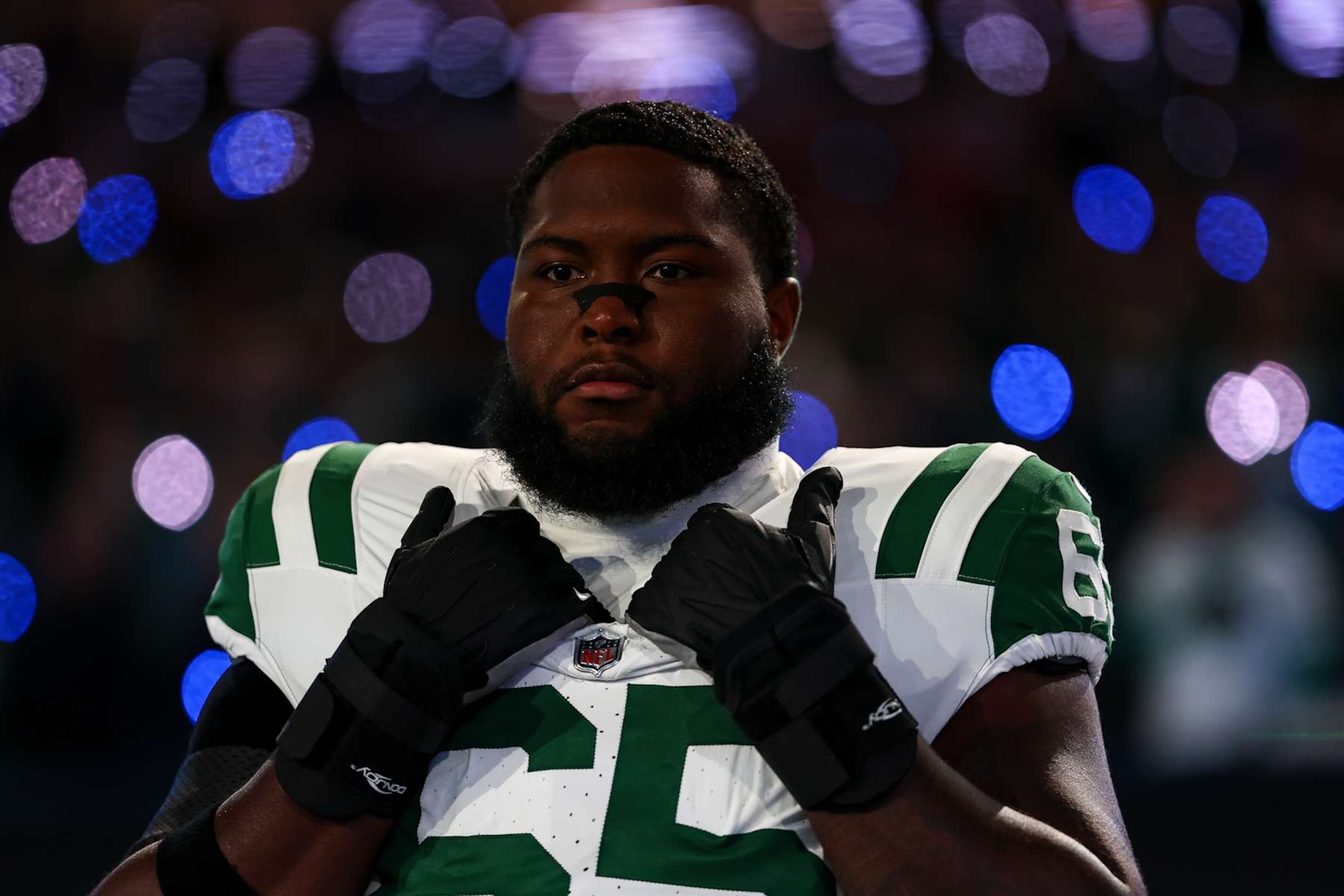 EAST RUTHERFORD, NEW JERSEY - OCTOBER 14: Xavier Newman #65 of the New York Jets stands on the sidelines during the national anthem prior to an NFL game against the Buffalo Bills at MetLife Stadium on October 14, 2024 in East Rutherford, New Jersey. (Photo by Kevin Sabitus/Getty Images)