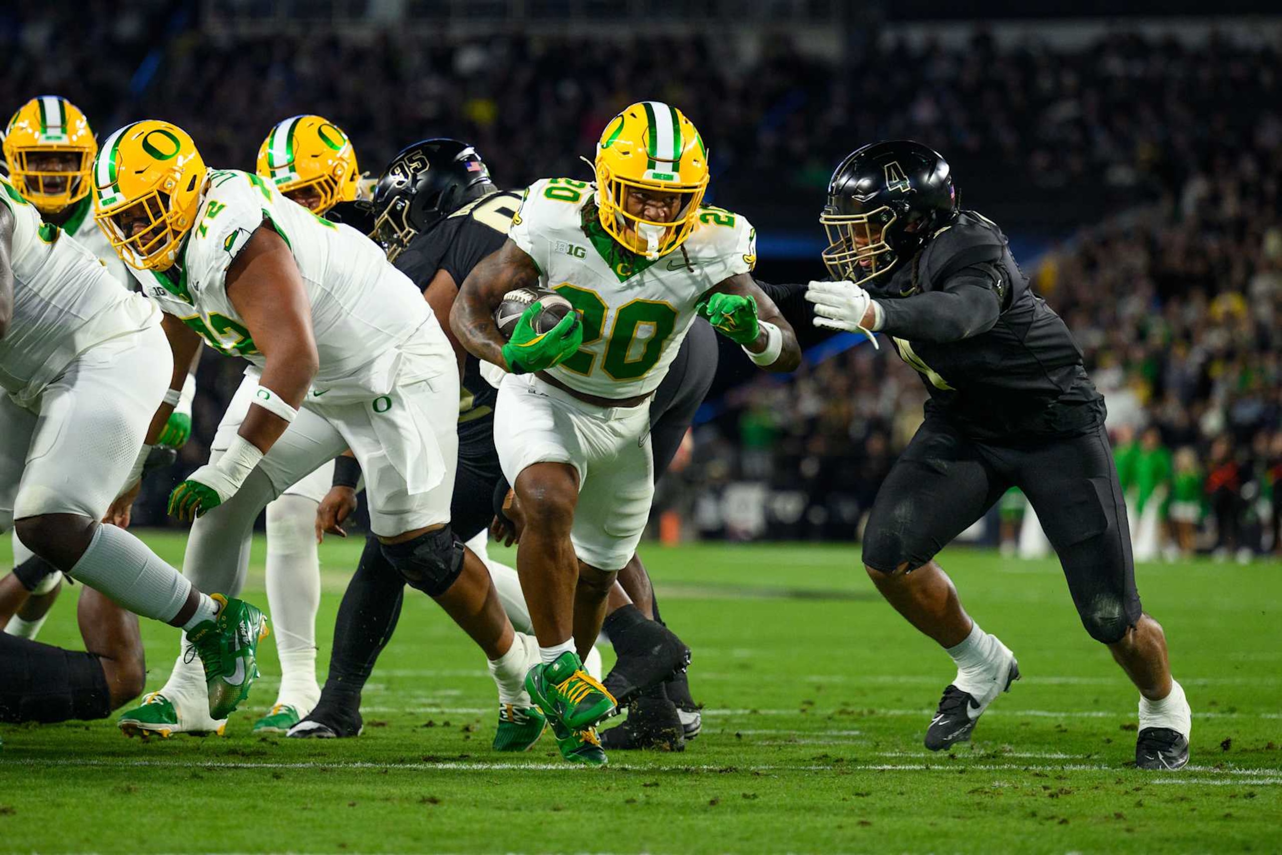 WEST LAFAYETTE, IN - OCTOBER 18: Oregon Ducks running back Jordan James (20) runs past Purdue Boilermakers linebacker Kydran Jenkins (4) for a touchdown during the college football game between the Purdue Boilermakers and Oregon Ducks on October 18, 2024, at Ross-Ade Stadium in West Lafayette, IN. (Photo by Zach Bolinger/Icon Sportswire via Getty Images)