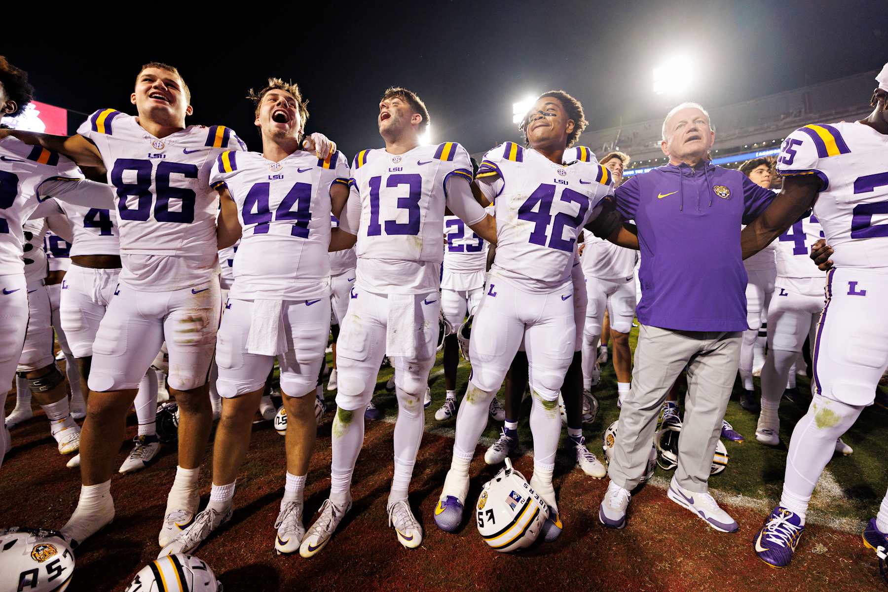 FAYETTEVILLE, ARKANSAS - OCTOBER 19: Head Coach Brian Kelly and players of the LSU Tigers sing the fight song with the crowd after a game against the Arkansas Razorbacks at Donald W. Reynolds Razorback Stadium on October 19, 2024 in Fayetteville, Arkansas. The Tigers defeated the Razorbacks 34-10. (Photo by Wesley Hitt/Getty Images) FAYETTEVILLE, ARKANSAS - OCTOBER 19: Head Coach Brian Kelly and players of the LSU Tigers sing the fight song with the crowd after a game against the Arkansas Razorbacks at Donald W. Reynolds Razorback Stadium on October 19, 2024 in Fayetteville, Arkansas. The Tigers defeated the Razorbacks 34-10. (Photo by Wesley Hitt/Getty Images)