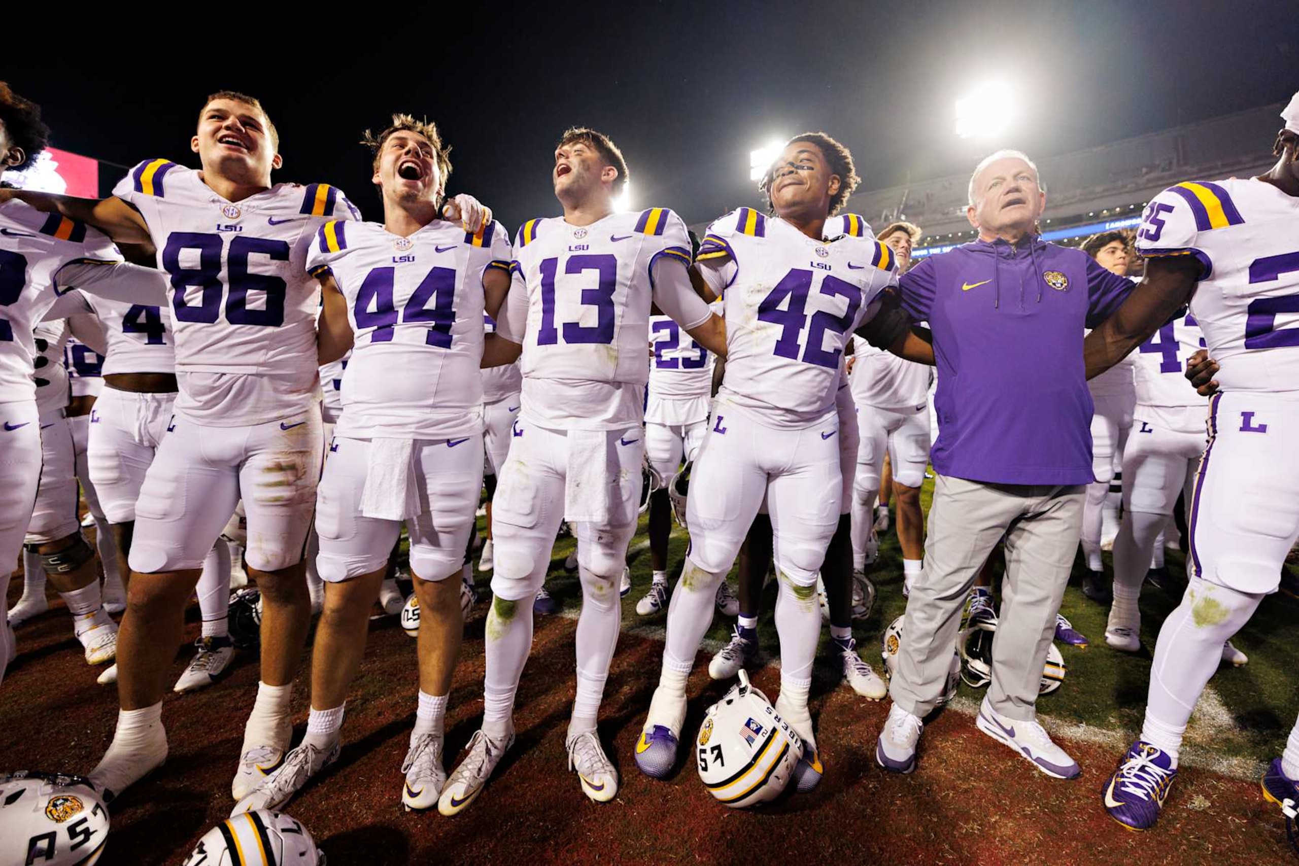FAYETTEVILLE, ARKANSAS - OCTOBER 19: Head Coach Brian Kelly and players of the LSU Tigers sing the fight song with the crowd after a game against the Arkansas Razorbacks at Donald W. Reynolds Razorback Stadium on October 19, 2024 in Fayetteville, Arkansas. The Tigers defeated the Razorbacks 34-10.  (Photo by Wesley Hitt/Getty Images)