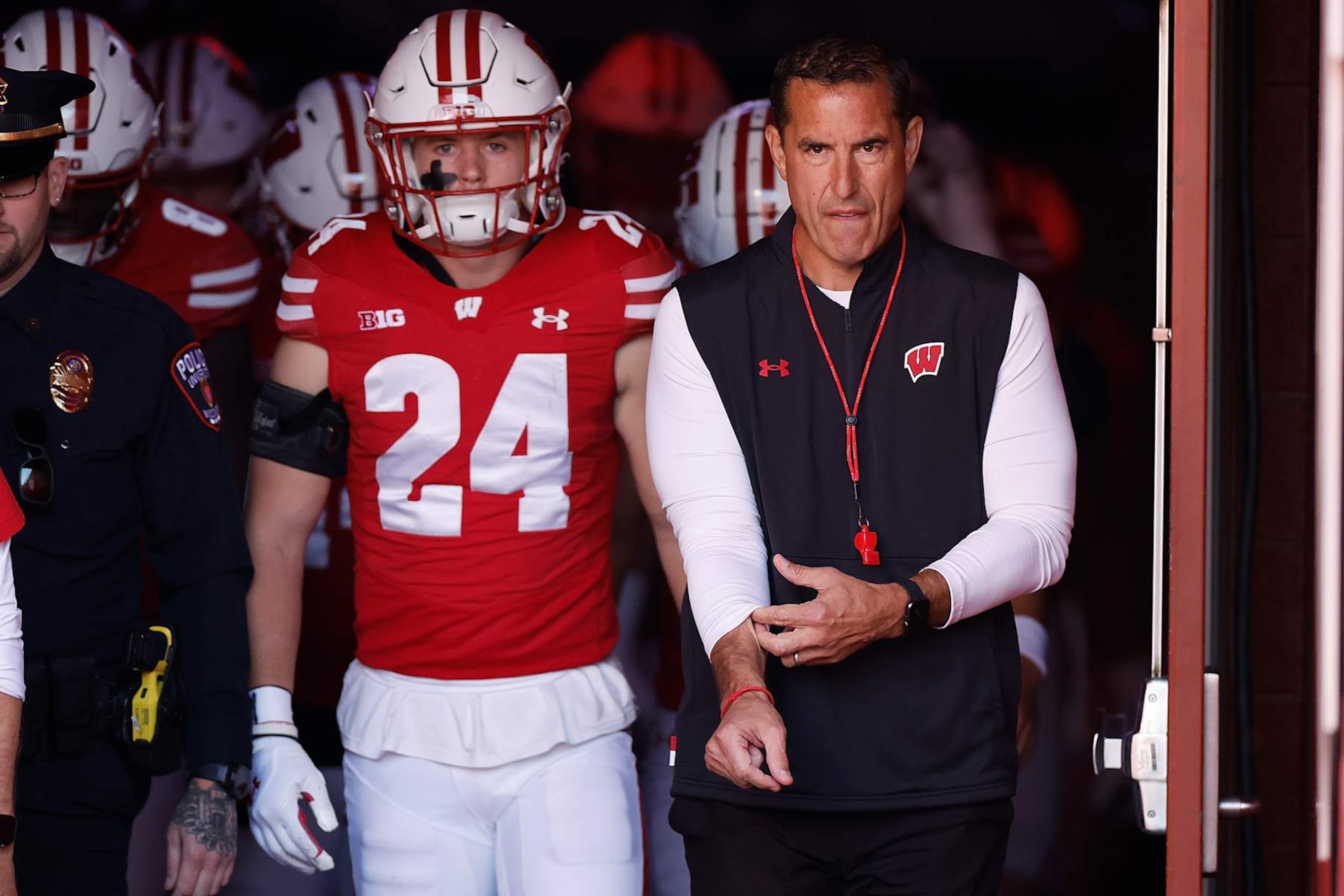 MADISON, WISCONSIN - OCTOBER 05: Head coach Luke Fickell (R) of the Wisconsin Badgers takes the field before the game against the Purdue Boilermakers at Camp Randall Stadium on October 05, 2024 in Madison, Wisconsin. (Photo by John Fisher/Getty Images)