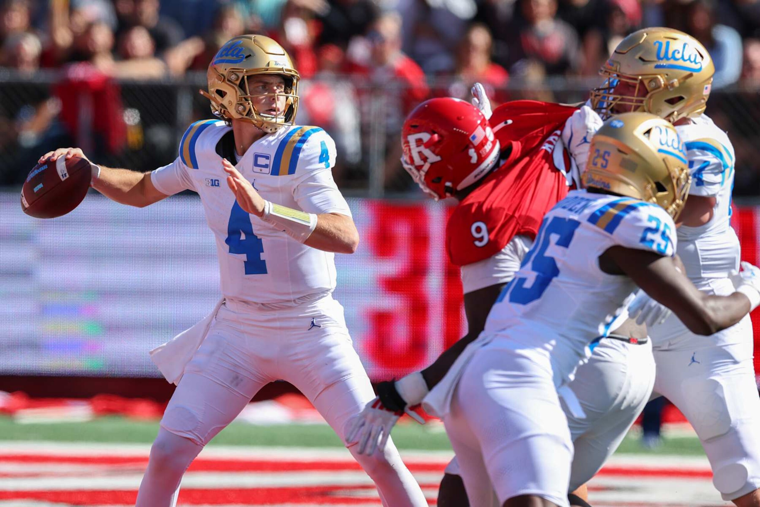 PISCATAWAY, NEW JERSEY - OCTOBER 19: Ethan Garbers #4 of the UCLA Bruins passes the ball during the first half of their game against the Rutgers Scarlet Knights at SHI Stadium on October 19, 2024 in Piscataway, New Jersey. (Photo by Ed Mulholland/Getty Images)