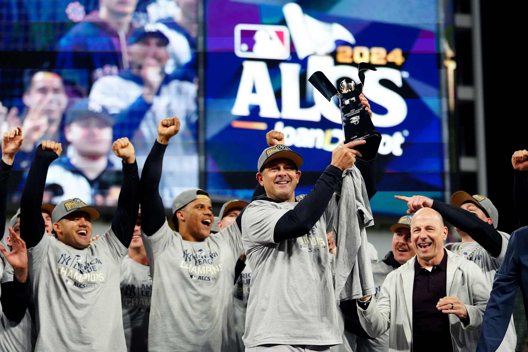 CLEVELAND, OH - OCTOBER 19:  Manager Aaron Boone #17 of the New York Yankees hoists the William Harridge Trophy after the Yankees defeated the Cleveland Guardians in Game 5 of the ALCS presented by loanDepot between the to advance to the 2024 Major League Baseball World Series at Progressive Field on Saturday, October 19, 2024 in Cleveland, Ohio. (Photo by Mary DeCicco/MLB Photos via Getty Images)