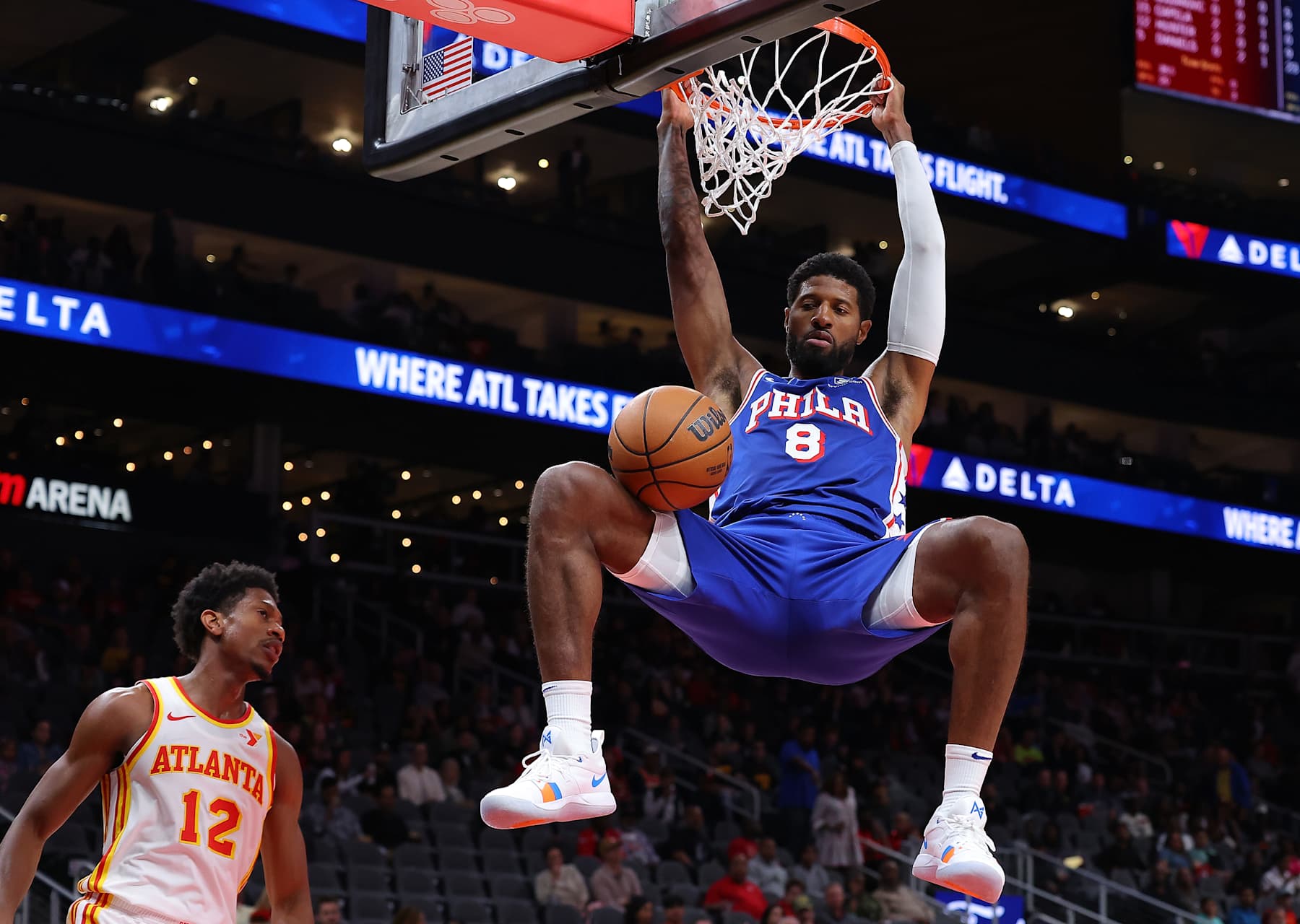 ATLANTA, GEORGIA - OCTOBER 14:  Paul George #8 of the Philadelphia 76ers dunks against De'Andre Hunter #12 of the Atlanta Hawks during the first quarter at State Farm Arena on October 14, 2024 in Atlanta, Georgia.  NOTE TO USER: User expressly acknowledges and agrees that, by downloading and/or using this photograph, user is consenting to the terms and conditions of the Getty Images License Agreement.  (Photo by Kevin C. Cox/Getty Images)