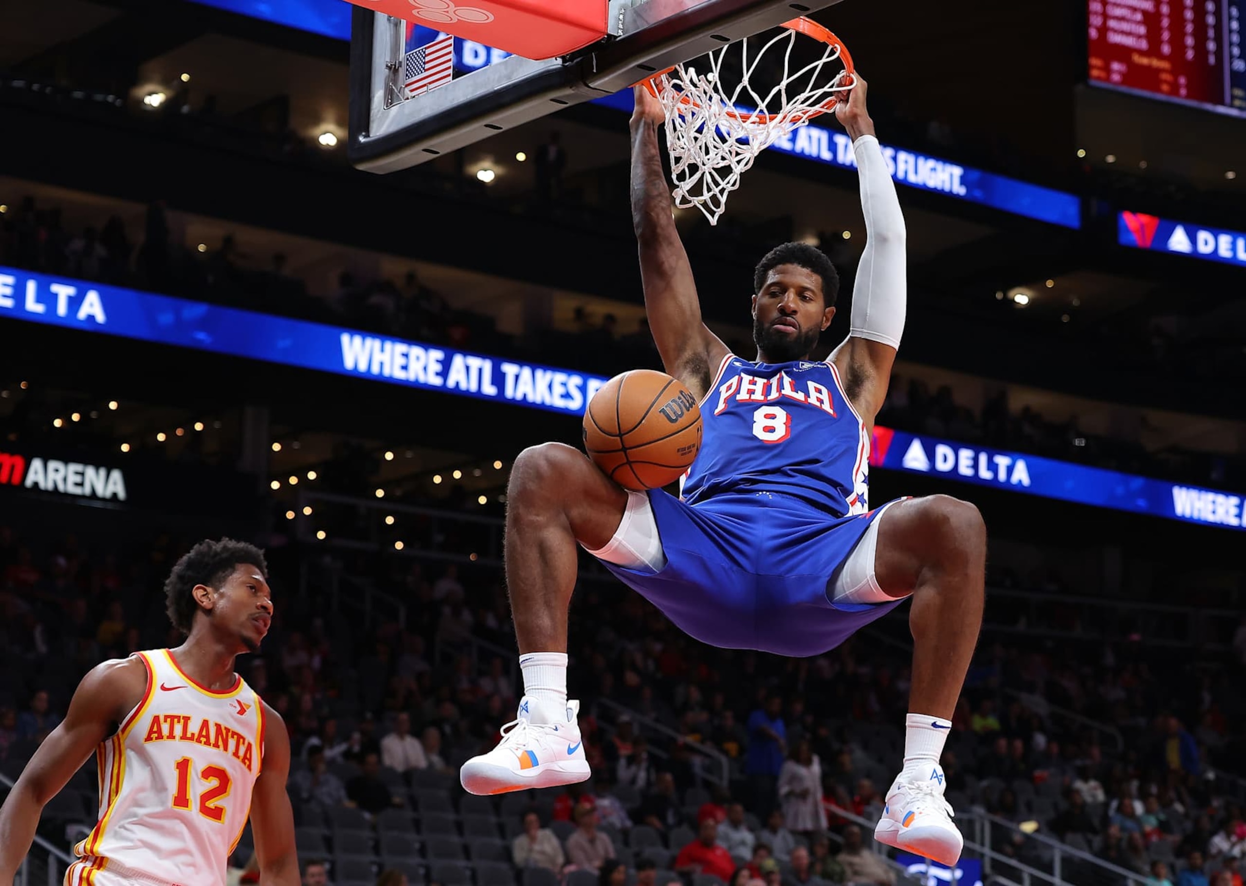 ATLANTA, GEORGIA - OCTOBER 14:  Paul George #8 of the Philadelphia 76ers dunks against De'Andre Hunter #12 of the Atlanta Hawks during the first quarter at State Farm Arena on October 14, 2024 in Atlanta, Georgia.  NOTE TO USER: User expressly acknowledges and agrees that, by downloading and/or using this photograph, user is consenting to the terms and conditions of the Getty Images License Agreement.  (Photo by Kevin C. Cox/Getty Images)