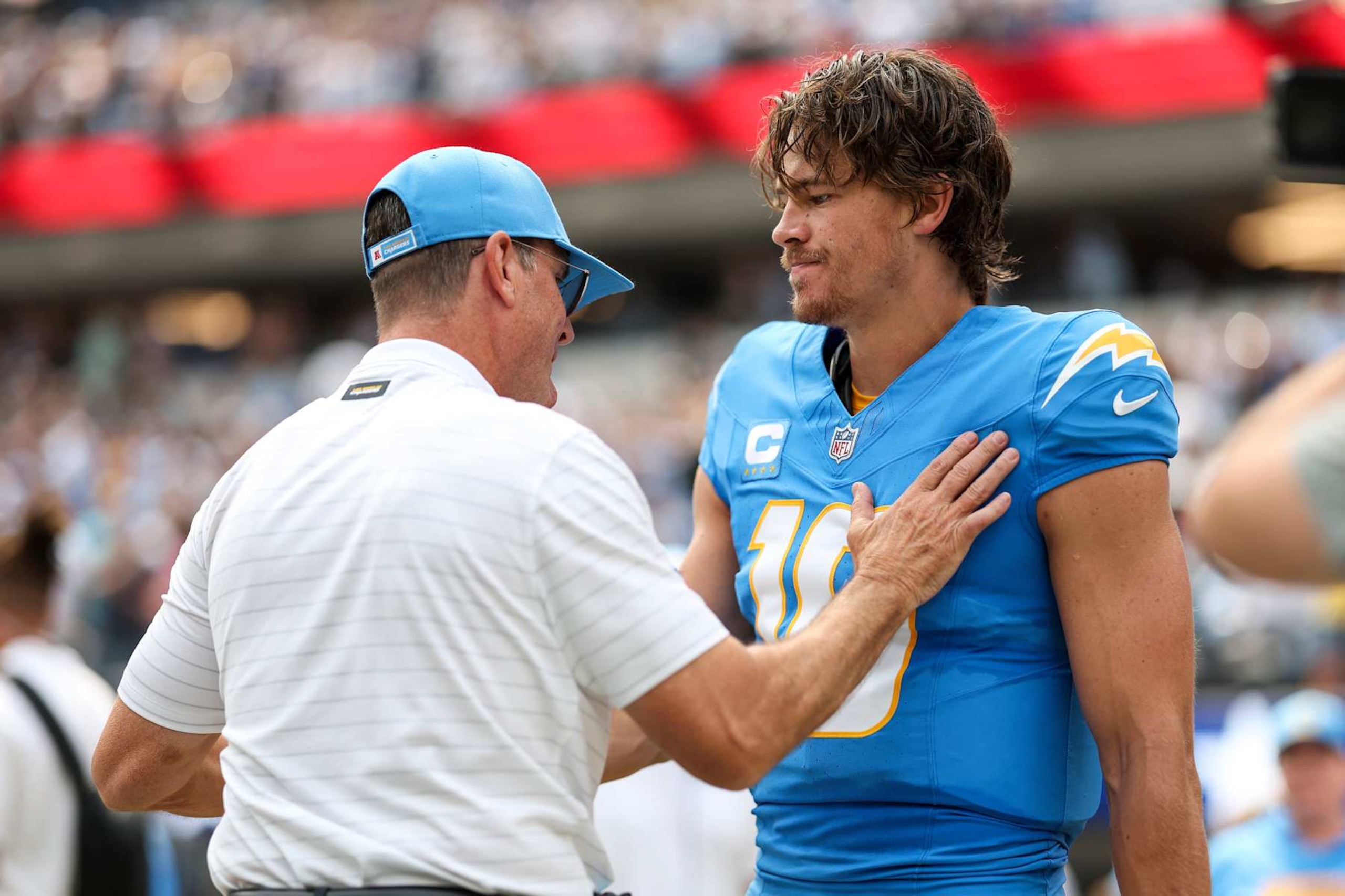INGLEWOOD, CALIFORNIA - SEPTEMBER 08: Head coach Jim Harbaugh of the Los Angeles Chargers and Justin Herbert #10 of the Los Angeles Chargers share a moment prior to an NFL football game between the Los Angeles Chargers and the Las Vegas Raiders at SoFi Stadium on September 08, 2024 in Inglewood, California. (Photo by Michael Owens/Getty Images) INGLEWOOD, CALIFORNIA - SEPTEMBER 08: Head coach Jim Harbaugh of the Los Angeles Chargers and Justin Herbert #10 of the Los Angeles Chargers share a moment prior to an NFL football game between the Los Angeles Chargers and the Las Vegas Raiders at SoFi Stadium on September 08, 2024 in Inglewood, California. (Photo by Michael Owens/Getty Images)