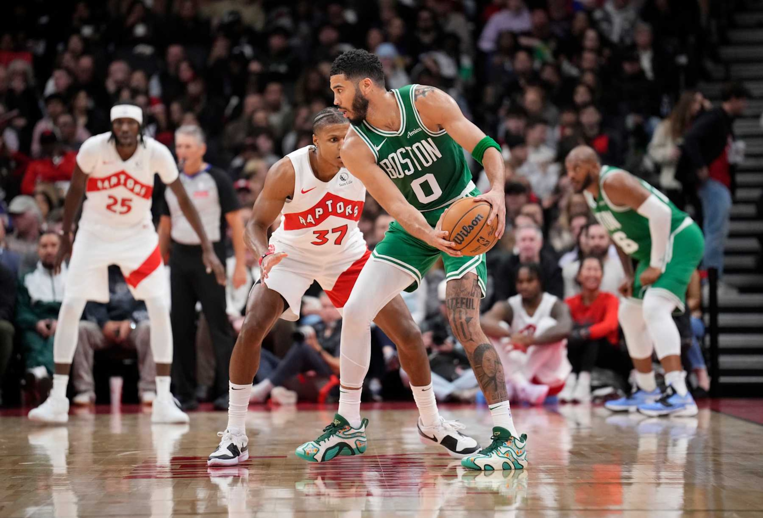 TORONTO, ON - OCTOBER 15: Jayson Tatum #0 of the Boston Celtics is guarded by Jahmi'us Ramsey #37 of the Toronto Raptors during the second half of their preseason basketball game at the Scotiabank Arena on October 15, 2024 in Toronto, Ontario, Canada. NOTE TO USER: User expressly acknowledges and agrees that, by downloading and/or using this Photograph, user is consenting to the terms and conditions of the Getty Images License Agreement. (Photo by Mark Blinch/Getty Images)