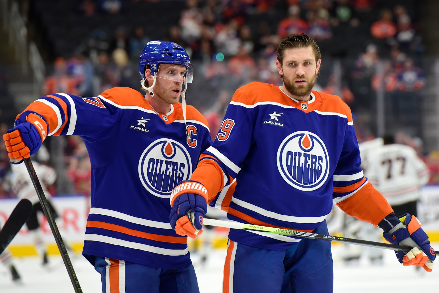 EDMONTON, CANADA  OCTOBER 12: Leon Draisaitl #29 and Connor McDavid #97 of the Edmonton Oilers have a conversation during warms up prior to the game against the Chicago Blackhawks at Rogers Place on October 12, 2024, in Edmonton, Alberta, Canada. (Photo by Leila Devlin/Getty Images)