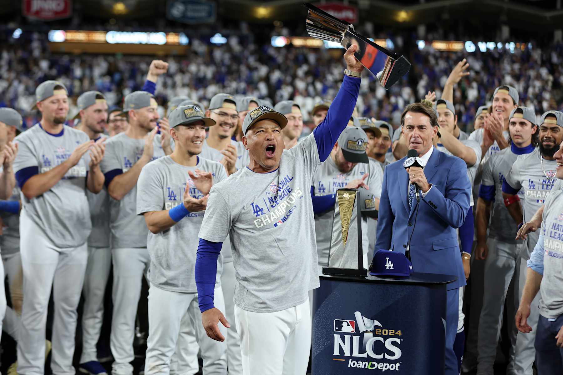 LOS ANGELES, CALIFORNIA - OCTOBER 20:  Manager Dave Roberts #30 of the Los Angeles Dodgers celebrates with the trophy after the Dodgers defeated the New York Mets to win Game Six of the National League Championship Series at Dodger Stadium on October 20, 2024 in Los Angeles, California. (Photo by Sean M. Haffey/Getty Images)