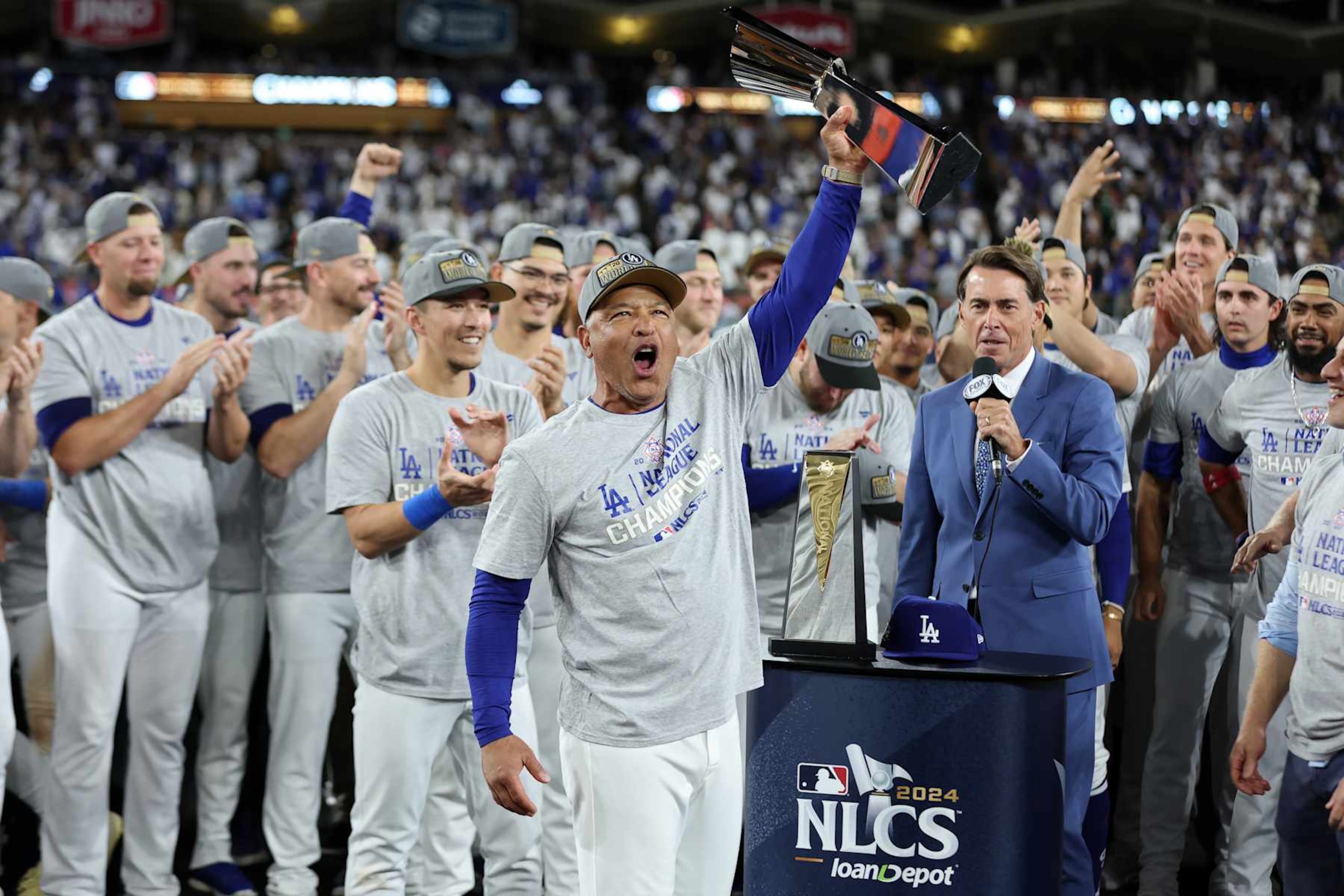 LOS ANGELES, CALIFORNIA - OCTOBER 20:  Manager Dave Roberts #30 of the Los Angeles Dodgers celebrates with the trophy after the Dodgers defeated the New York Mets to win Game Six of the National League Championship Series at Dodger Stadium on October 20, 2024 in Los Angeles, California. (Photo by Sean M. Haffey/Getty Images)