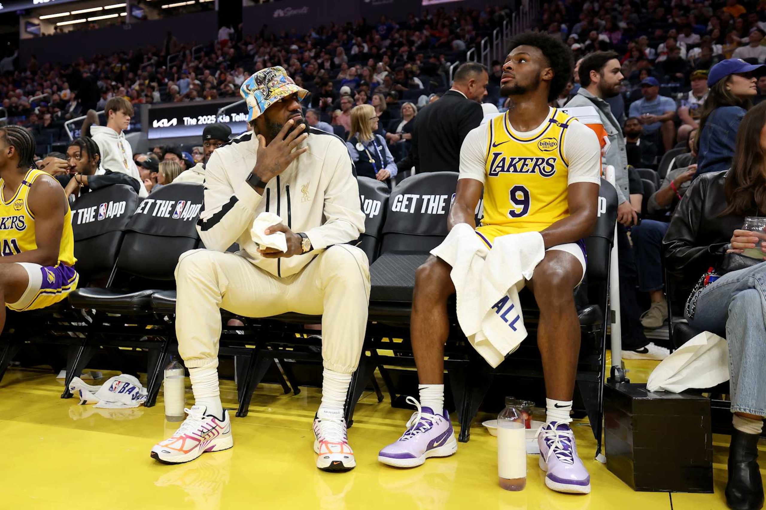 SAN FRANCISCO, CALIFORNIA - OCTOBER 18: LeBron James #23 of the Los Angeles Lakers talks to his son, Bronny James #9, during a timeout of their preseason game against the Golden State Warriors at Chase Center on October 18, 2024 in San Francisco, California.  NOTE TO USER: User expressly acknowledges and agrees that, by downloading and/or using this photograph, user is consenting to the terms and conditions of the Getty Images License Agreement.  (Photo by Ezra Shaw/Getty Images)