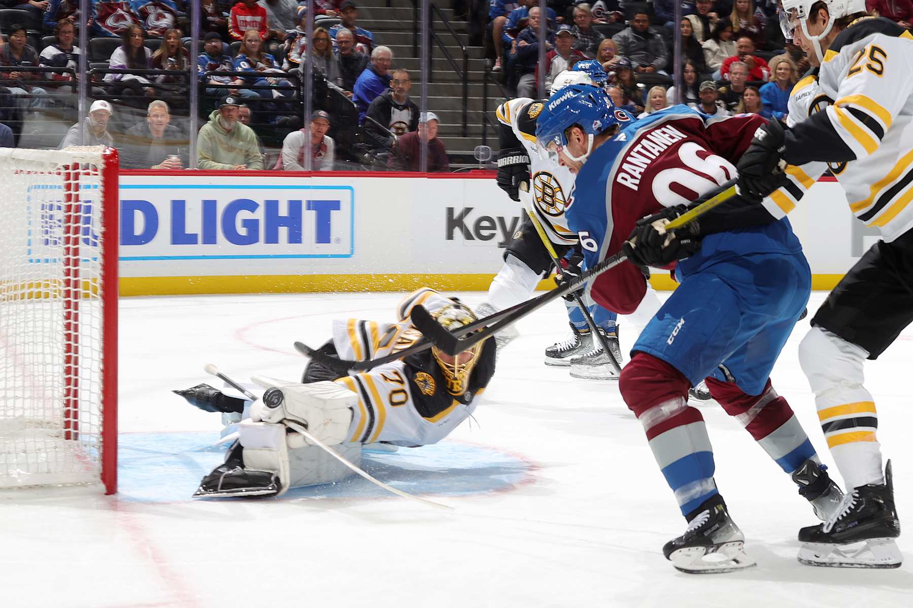 DENVER, COLORADO - OCTOBER 16: Goaltender Joonas Korpisalo #70 of the Boston Bruins makes a diving save against Mikko Rantanen #96 of the Colorado Avalanche at Ball Arena on October 16, 2024 in Denver, Colorado. (Photo by Michael Martin/NHLI via Getty Images)