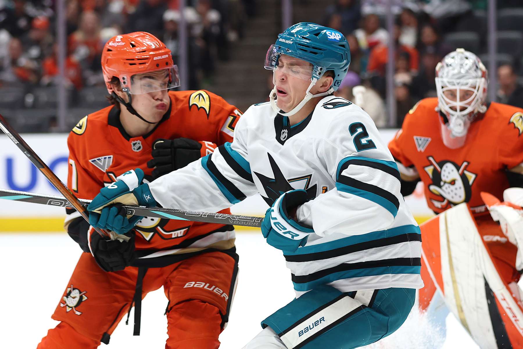 ANAHEIM, CALIFORNIA - OCTOBER 22: Olen Zellweger #51 of the Anaheim Ducks pushes Will Smith #2 of the San Jose Sharks during the third period of a game at Honda Center on October 22, 2024 in Anaheim, California. (Photo by Sean M. Haffey/Getty Images)