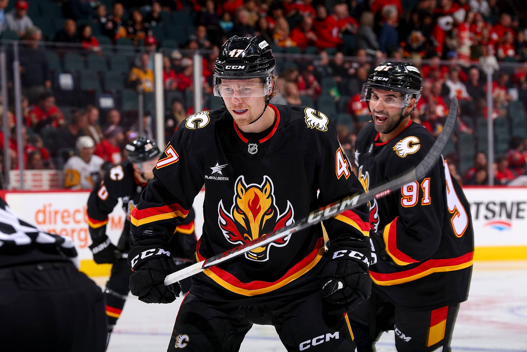 CALGARY, AB - OCTOBER 22: Connor Zary #47 of the Calgary Flames prepares to face off against the Pittsburgh Penguins at Scotiabank Saddledome on October 22, 2024 in Calgary, Alberta, Canada. (Photo by Gerry Thomas/NHLI via Getty Images)