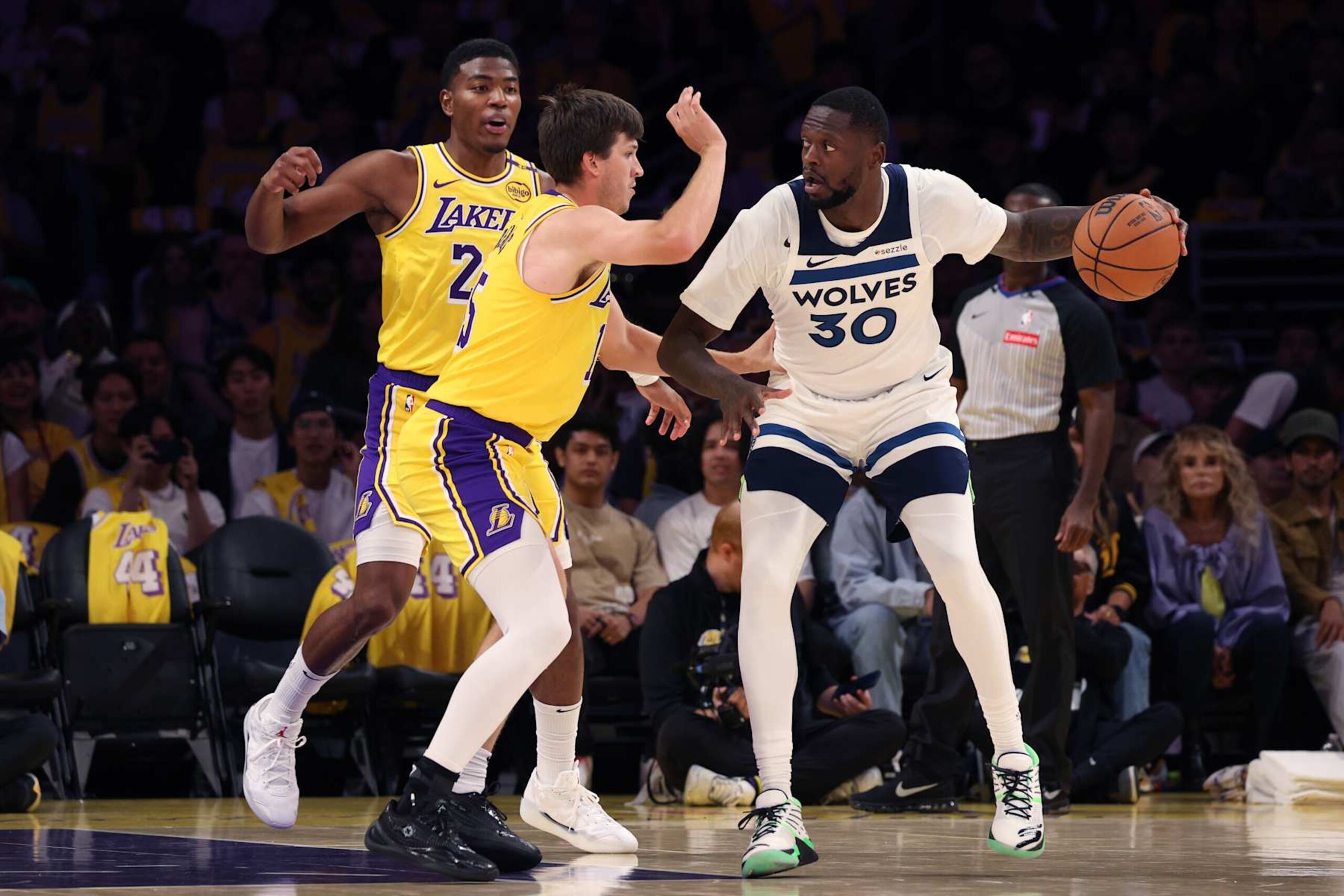 LOS ANGELES, CALIFORNIA - OCTOBER 22: Julius Randle #30 of the Minnesota Timberwolves makes a move on Austin Reaves #15 and Rui Hachimura #28 of the Los Angeles Lakers during the first quarter at Crypto.com Arena on October 22, 2024 in Los Angeles, California. (Photo by Harry How/Getty Images) LOS ANGELES, CALIFORNIA - OCTOBER 22: Julius Randle #30 of the Minnesota Timberwolves makes a move on Austin Reaves #15 and Rui Hachimura #28 of the Los Angeles Lakers during the first quarter at Crypto.com Arena on October 22, 2024 in Los Angeles, California. (Photo by Harry How/Getty Images)