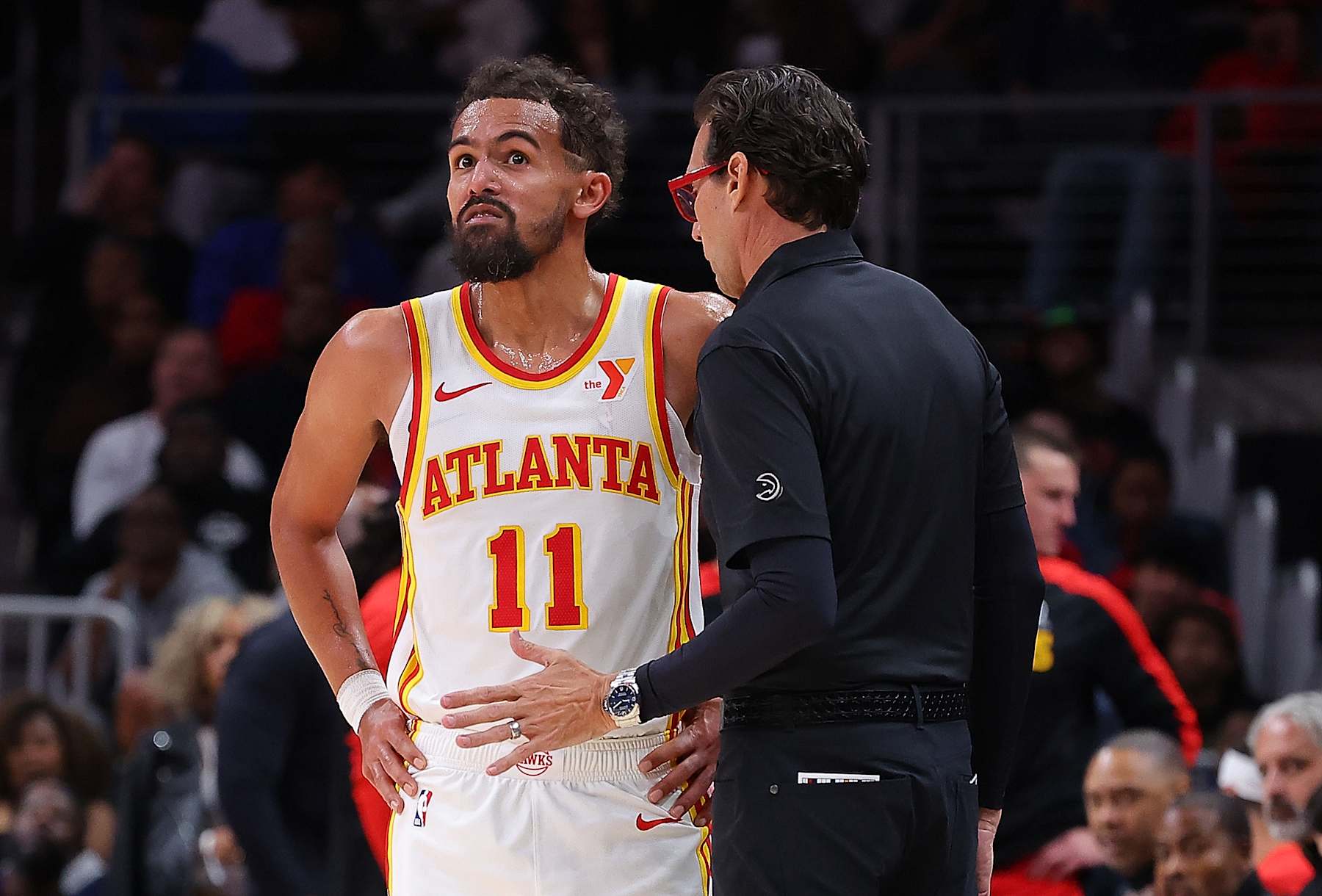 ATLANTA, GEORGIA - OCTOBER 14:  Head coach Quin Snyder of the Atlanta Hawks converses with Trae Young #11 against the Philadelphia 76ers during the third quarter at State Farm Arena on October 14, 2024 in Atlanta, Georgia.  NOTE TO USER: User expressly acknowledges and agrees that, by downloading and/or using this photograph, user is consenting to the terms and conditions of the Getty Images License Agreement.  (Photo by Kevin C. Cox/Getty Images)