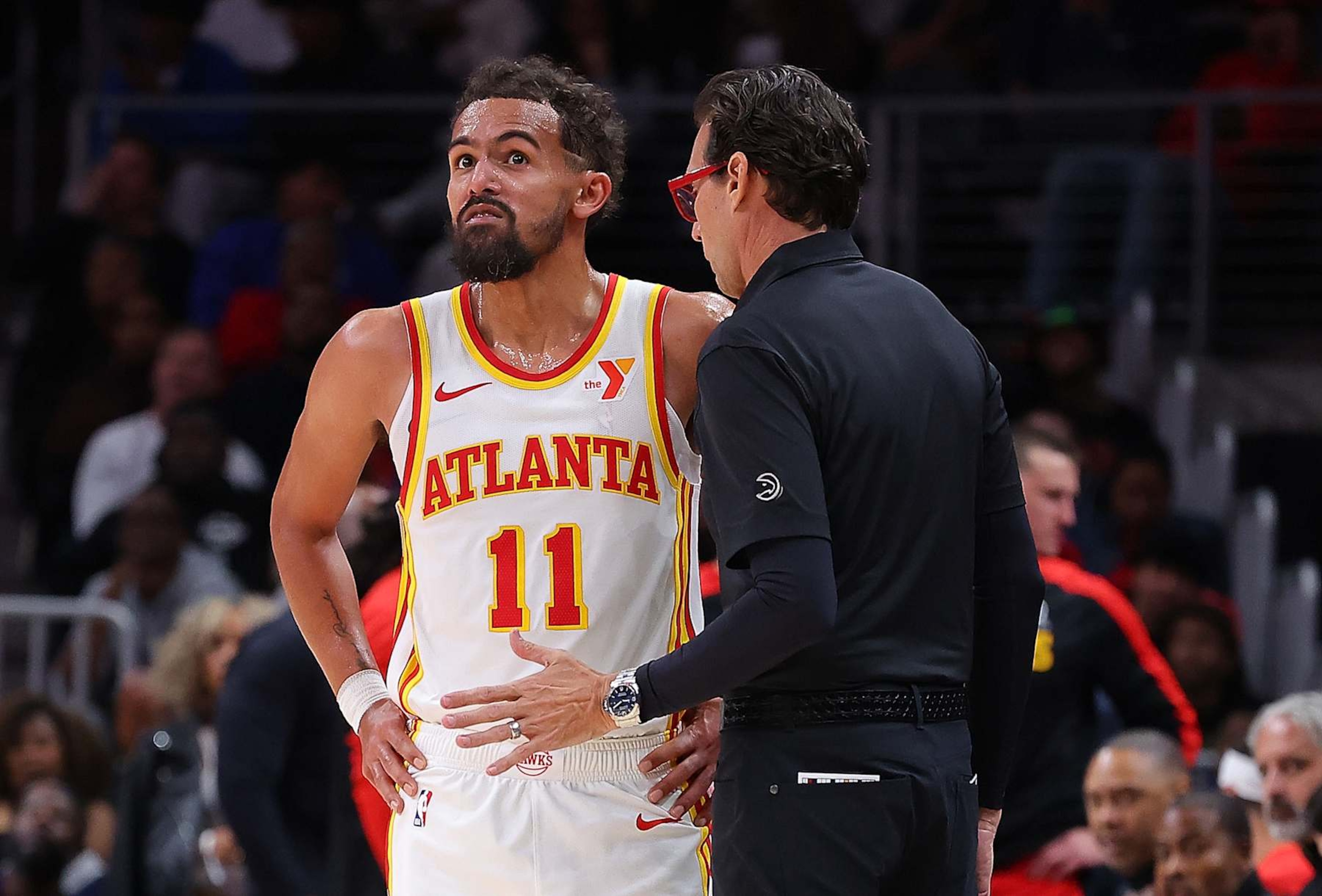 ATLANTA, GEORGIA - OCTOBER 14: Head coach Quin Snyder of the Atlanta Hawks converses with Trae Young #11 against the Philadelphia 76ers during the third quarter at State Farm Arena on October 14, 2024 in Atlanta, Georgia. NOTE TO USER: User expressly acknowledges and agrees that, by downloading and/or using this photograph, user is consenting to the terms and conditions of the Getty Images License Agreement. (Photo by Kevin C. Cox/Getty Images) ATLANTA, GEORGIA - OCTOBER 14: Head coach Quin Snyder of the Atlanta Hawks converses with Trae Young #11 against the Philadelphia 76ers during the third quarter at State Farm Arena on October 14, 2024 in Atlanta, Georgia. NOTE TO USER: User expressly acknowledges and agrees that, by downloading and/or using this photograph, user is consenting to the terms and conditions of the Getty Images License Agreement. (Photo by Kevin C. Cox/Getty Images)