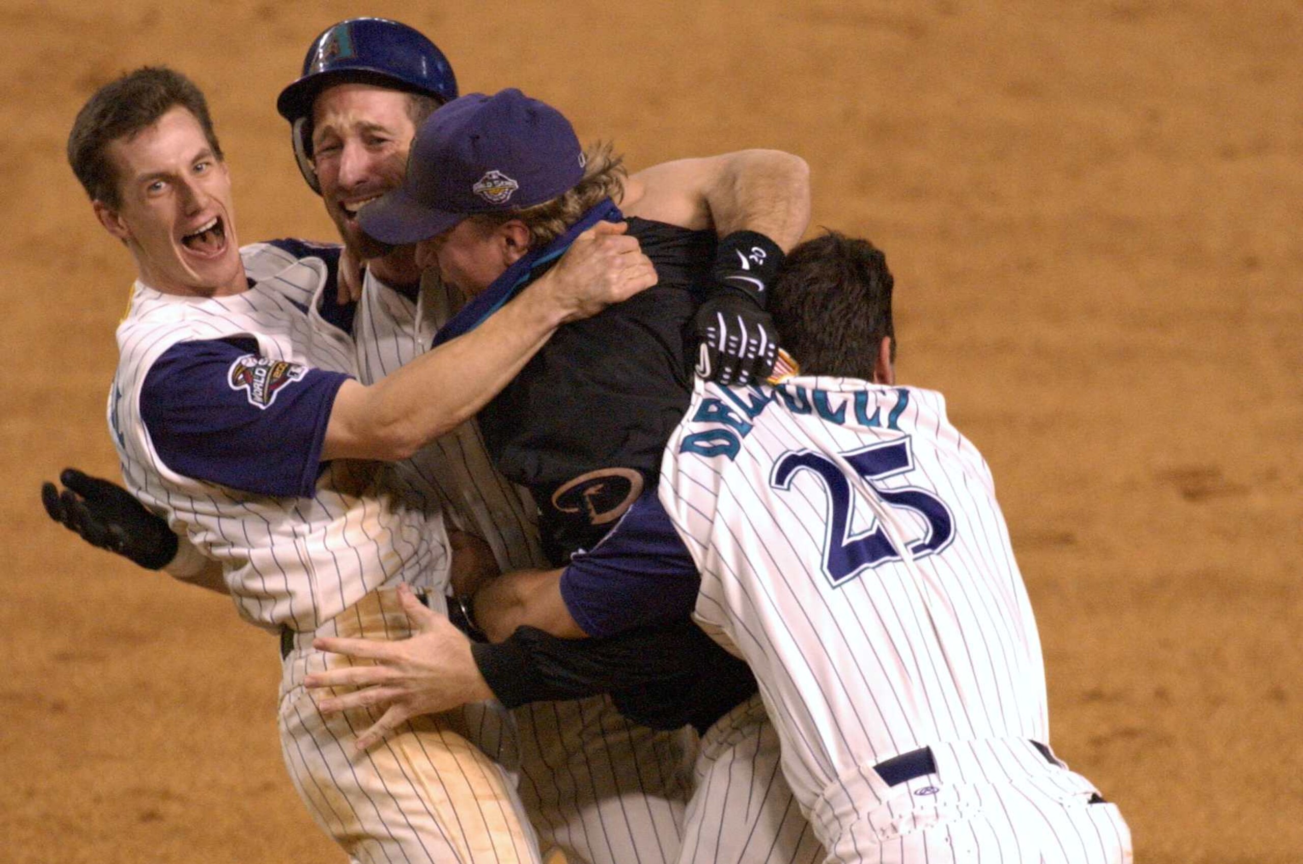 4 Nov 2001: Craig Counsell #4, Luis Gonzalez #20, Curt Schilling #38 and David Dellucci #36 of the Arizona Diamondbacks celebrate defeating the New York Yankees to win game seven of the Major League Baseball World Series at Bank One Ballpark in Phoenix, Arizona. DIGITAL IMAGE. Mandatory Credit: Matthew Stockman/ALLSPORT