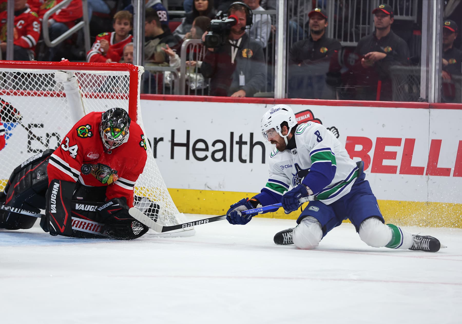 CHICAGO, IL - OCTOBER 22: Chicago Blackhawks goaltender Petr Mrazek (34) makes the save against Vancouver Canucks right wing Conor Garland (8) during the second period on October 22, 2024 at the United Center in Chicago,Illinois. (Photo by Melissa Tamez/Icon Sportswire via Getty Images)